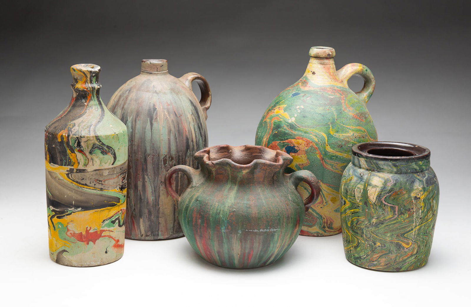 SIX AMERICAN FOLK ART STONEWARE VESSELS IN MARBELIZED PAINT. (1 of 5)