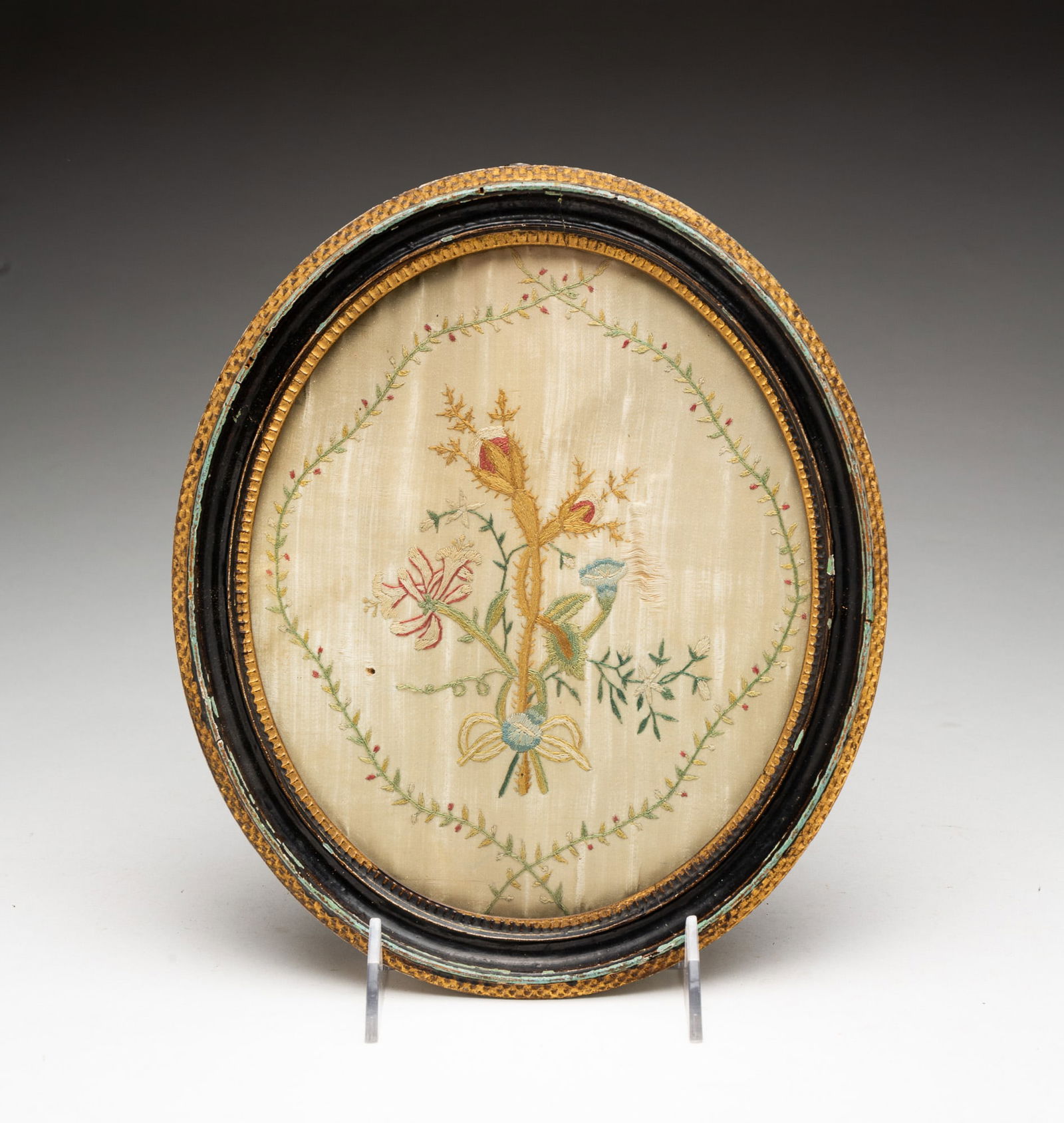 AMERICAN FLORAL EMBROIDERY ON SILK.: 18th Century. Vine border encircling a bouquet of flowers and thistles. 9.75"h. 8.25"w.