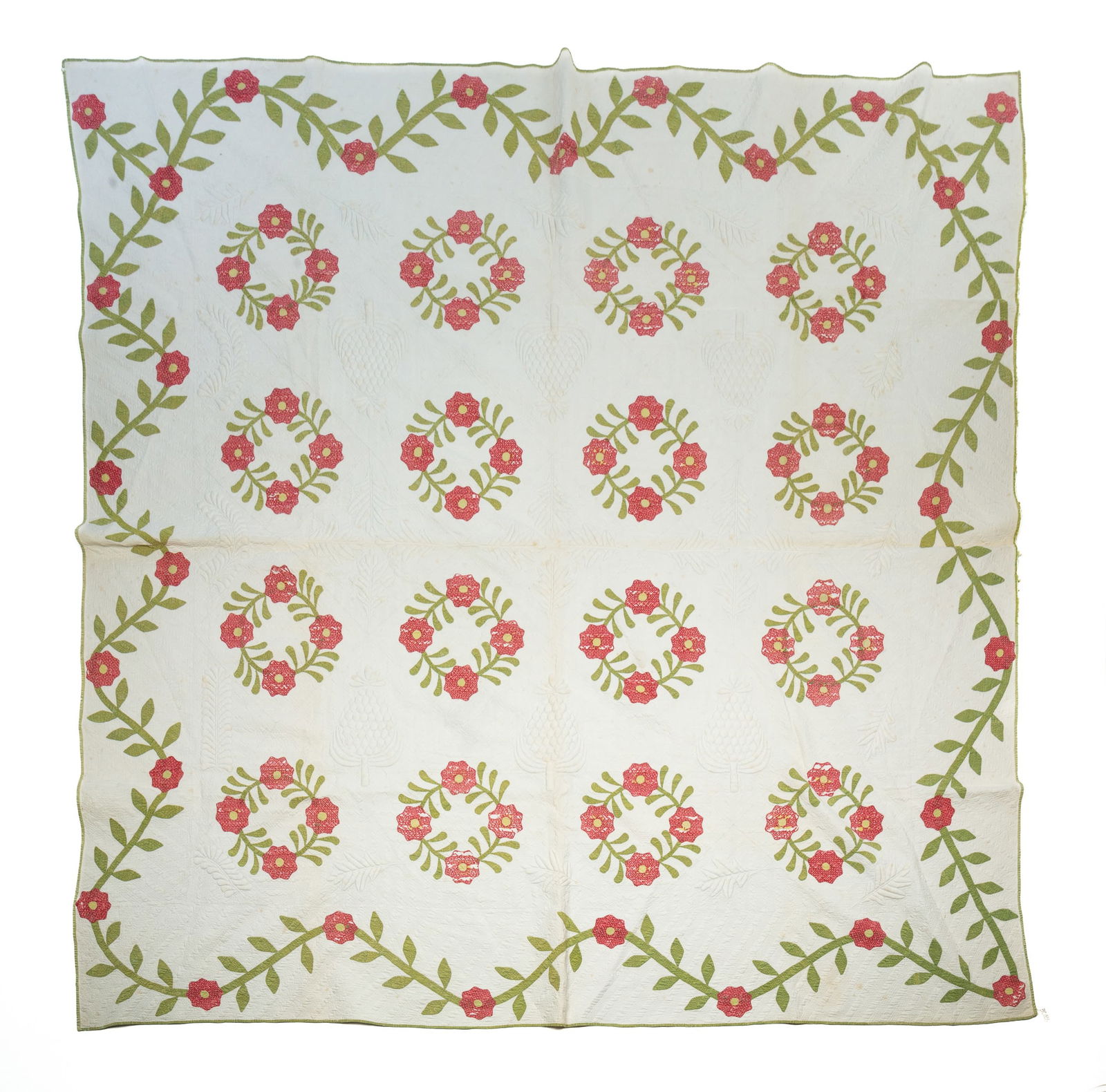 AMERICAN COTTON APPLIQUE AND TRAPUNTO QUILT.: Mid-19th Century. Vining floral border, wreaths of florals and trapunto leafy branches, plumes, and pinecones.Provenance: From the Lifetime Quilt and Textile Collection of Louise A. Veninga (Santa Cru