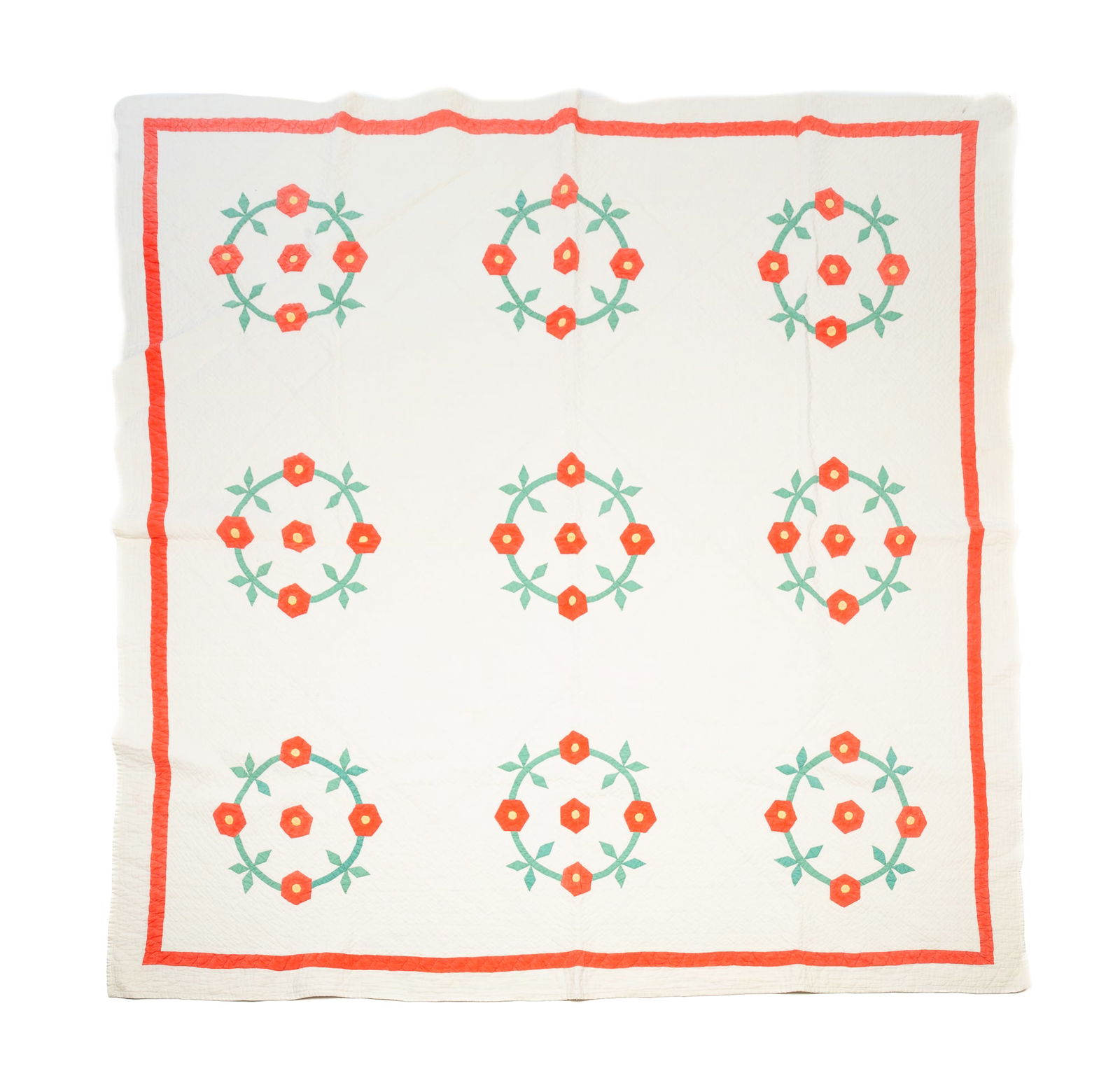 AMERICAN COTTON APPLIQUE FLORAL QUILT.: Mid-20th Century. Hand-stitched. In solid watermelon, green, and yellow fabrics on a white background. Nine floral wreaths of flowers make the center.Provenance: From the Lifetime Quilt and Textile