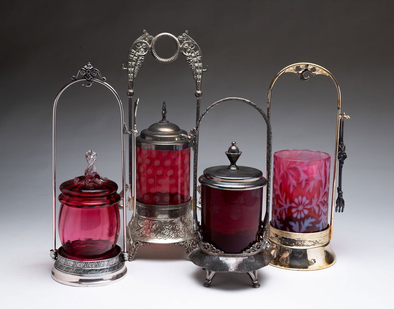 FOUR AMERICAN PICKLE CASTERS WITH CRANBERRY INSERTS. (1 of 5)