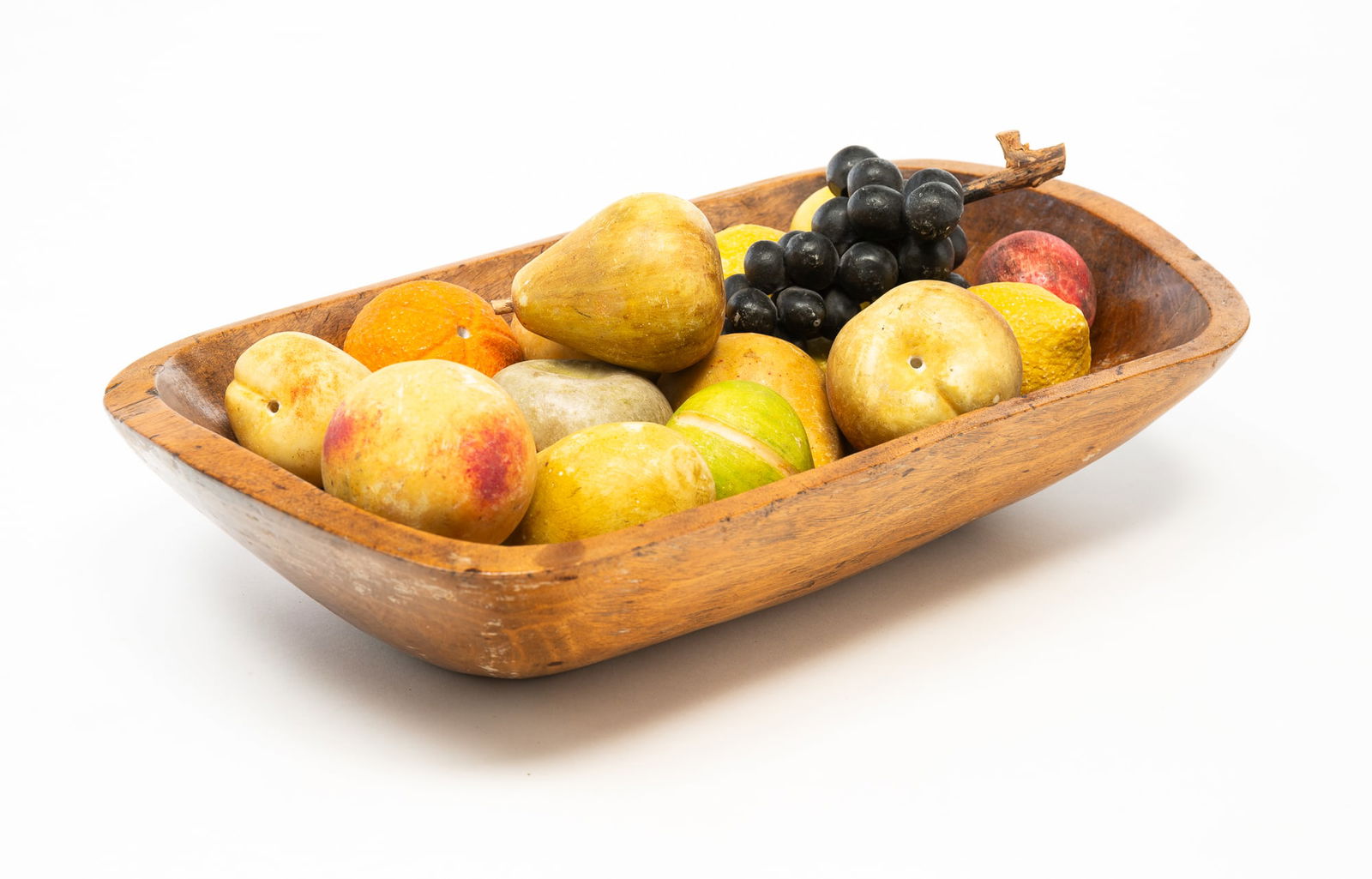 AMERICAN CARVED PINE TRENCHER WITH EIGHTEEN PIECES OF STONE FRUIT. Trencher, 4"h. 18"l. 10"d. (1 of 4)