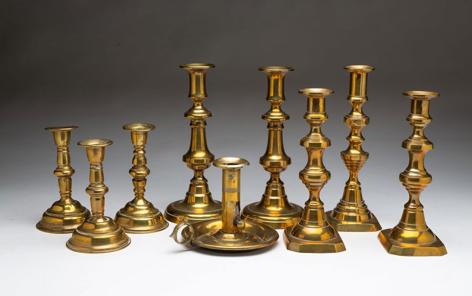 NINE VICTORIAN BRASS CANDLE STICKS. Largest, 9"h. (1 of 5)