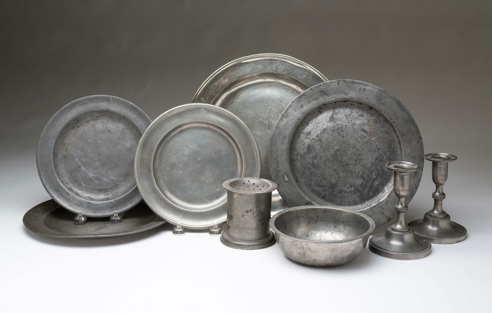 NINE PEWTER TABLEWARE ITEMS, INCL. PAIR OF CANDLESTICKS. Plate, 10.75"d. Sander, 3.5"h. 3.25"d. (1 of 4)