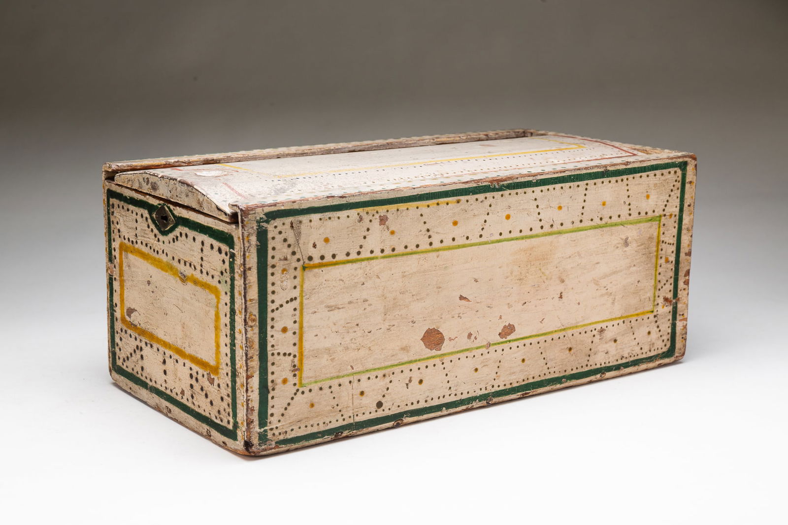 WONDERFUL AMERICAN FOLK ART PAINT-DECORATED POPLAR SLIDE LID BOX. 6.5"h. 15.75"w. 8.75"d.: Mid-19th Century. Simple construction, lid with finger grip, and chamfered edges. Original white paint, yellow, red, and green striping with yellow, red, and green small dot-patterned
