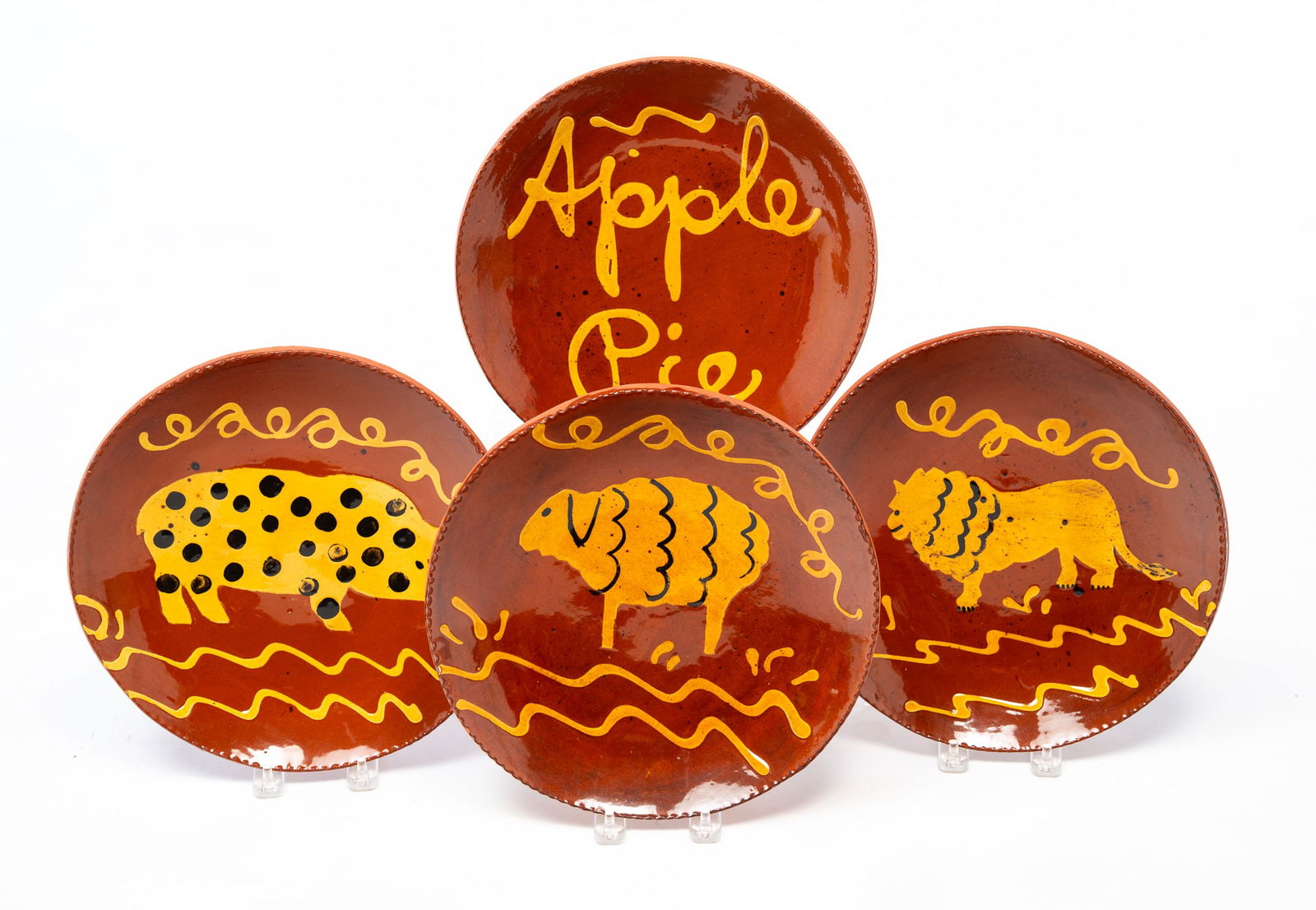 FOUR BREININGER POTTERY (ROBESONIA, PENNSYLVANIA) REDWARE PLATES. 10.75"d. (1 of 7)