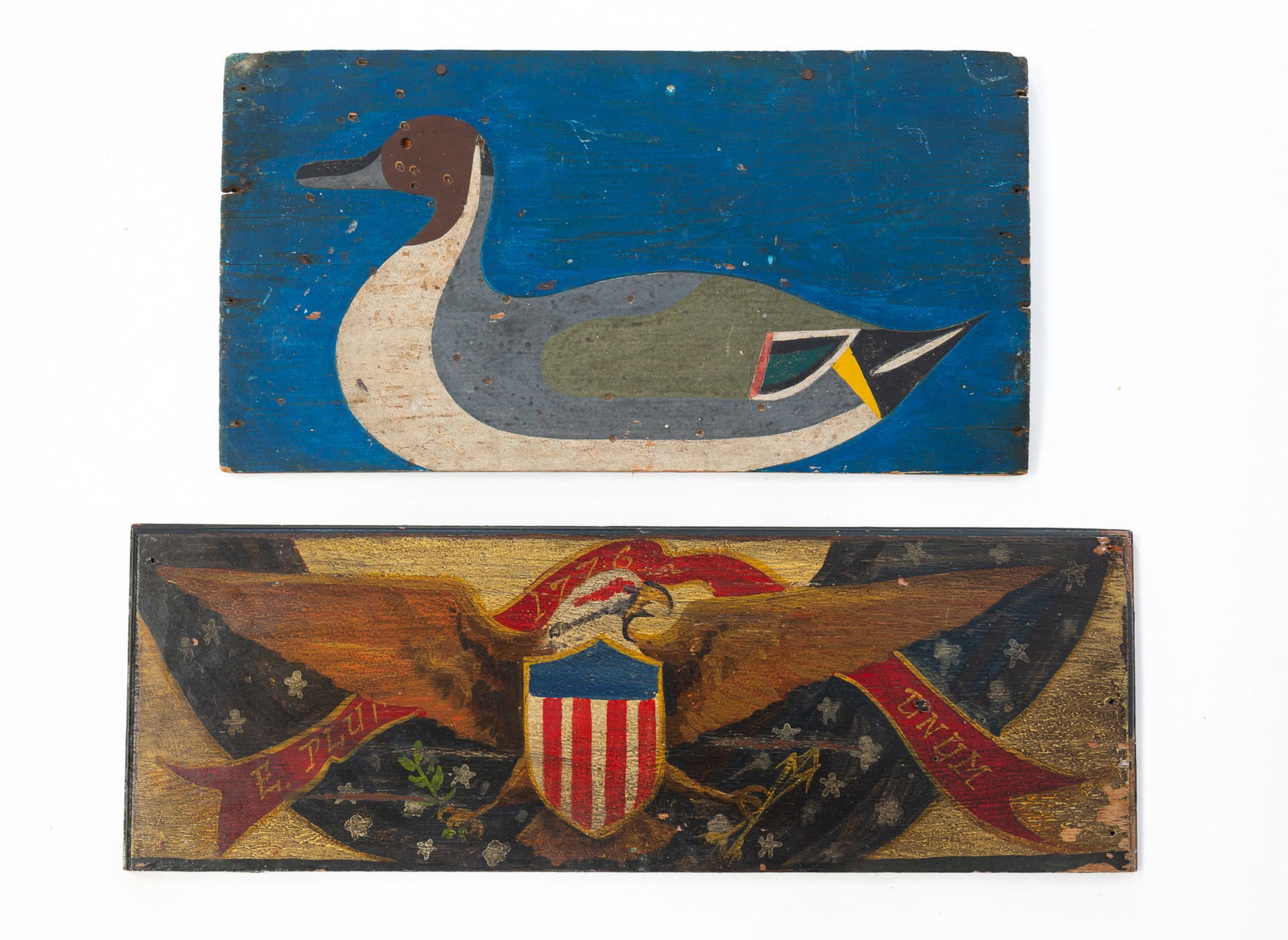 TWO AMERICAN FOLK ART PAINT-DECORATED WOOD PANELS. Eagle, 8.75"h. 24"w. Duck, 10.5"h. 19.5"w.: 20th Century. A pintail duck on pine, incised outline on a dark blue background with duck in natural colors. Original paint. And an oak panel with spread-winged eagle, red, white, and blue shield on c