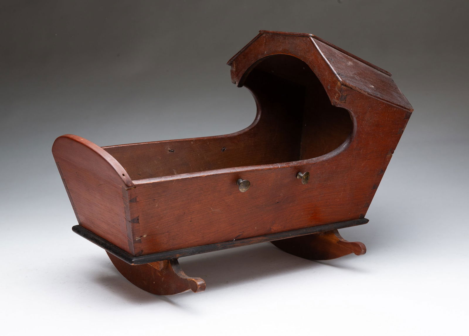 AMERICAN WALNUT DOLL-SIZED CRADLE. 10.75"h. 9"w. 14.5"l. (1 of 4)