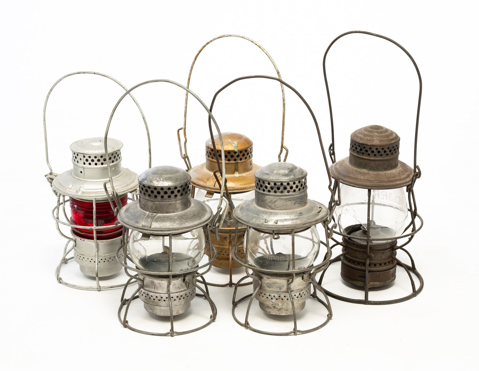 FIVE AMERICAN RAILROAD LANTERNS. Largest, 16.5"h.: First quarter 20th Century. Two are Atchison, Topeka, and Santa Fe with red lenses and one clear with acid-etched AT & SFRY", Kansas City Railway, Union Pacific Railroad with acid-etched clear lens,