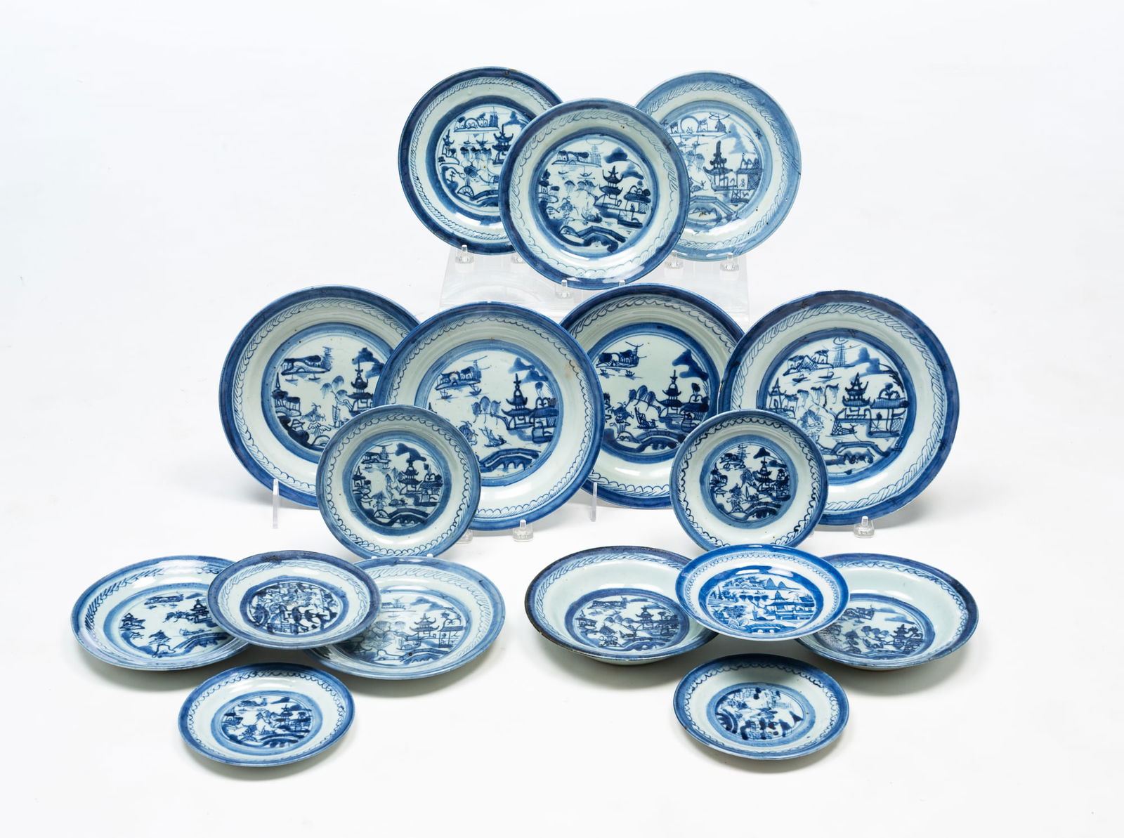 LARGE GROUP OF CHINESE BLUE AND WHITE PORCELAIN CANTON PLATES AND BOWLS. Largest, 8.75"d.: Ca. 1800. Four 8.75" plates, five 7.5" plates, six 5.75" plates, and two 7" bowls.SHIPPING: All purchases from Amelia Jeffers, Auctioneers & Appraisers may be picked up by you or your designated