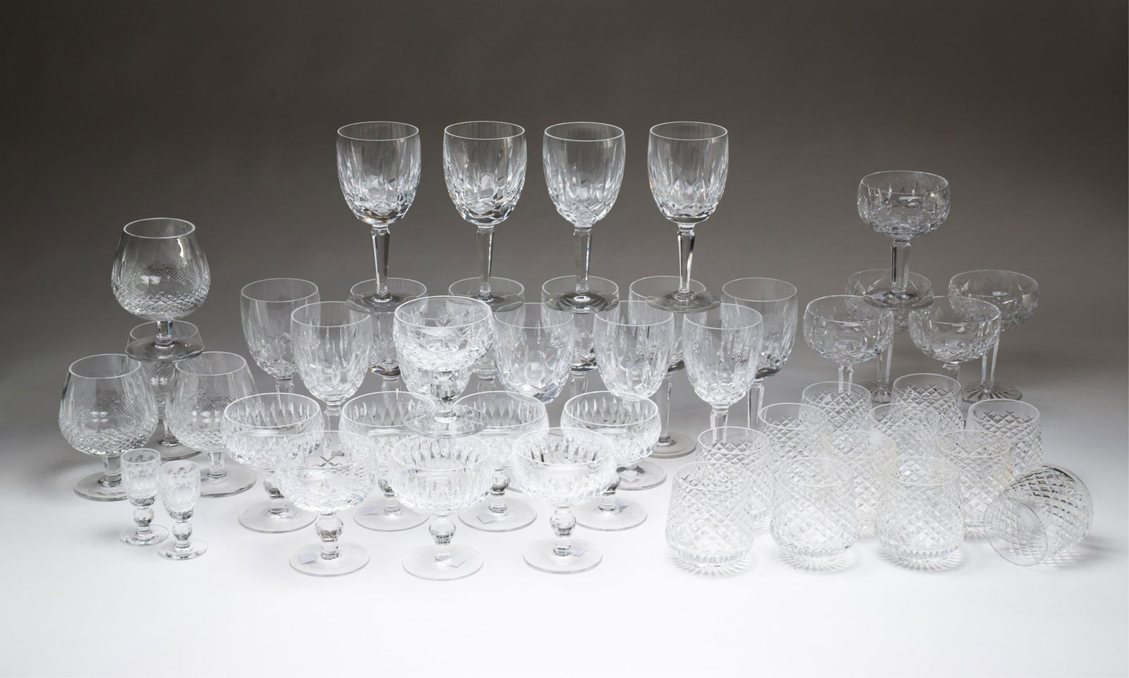 COLLECTION OF WATERFORD CUT CRYSTAL TABLEWARE. Kildare glasses, 5.25"h.: Irish, Late 20th Century. Twelve "Alana" pattern roly-poly tumblers, 3.5"h. Fifteen "Kildare" pattern godblets, 7"h. Three "Kildare" champagne glasses, 5.25"h. Four "Colleen" pattern brandy glasses, 5