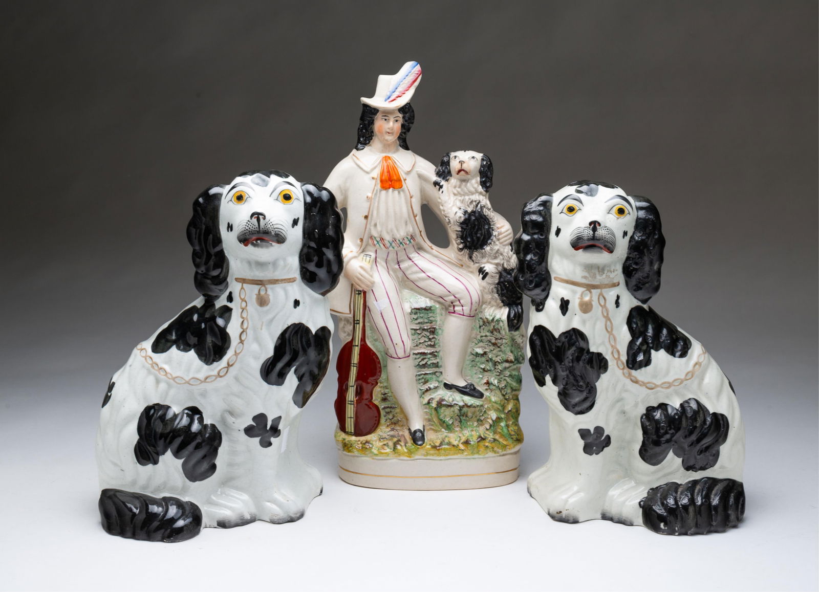 THREE STAFFORDSHIRE FIGURINES. Man, 13.25"h. Male, 10.5"h. Female, 10"h. (1 of 4)