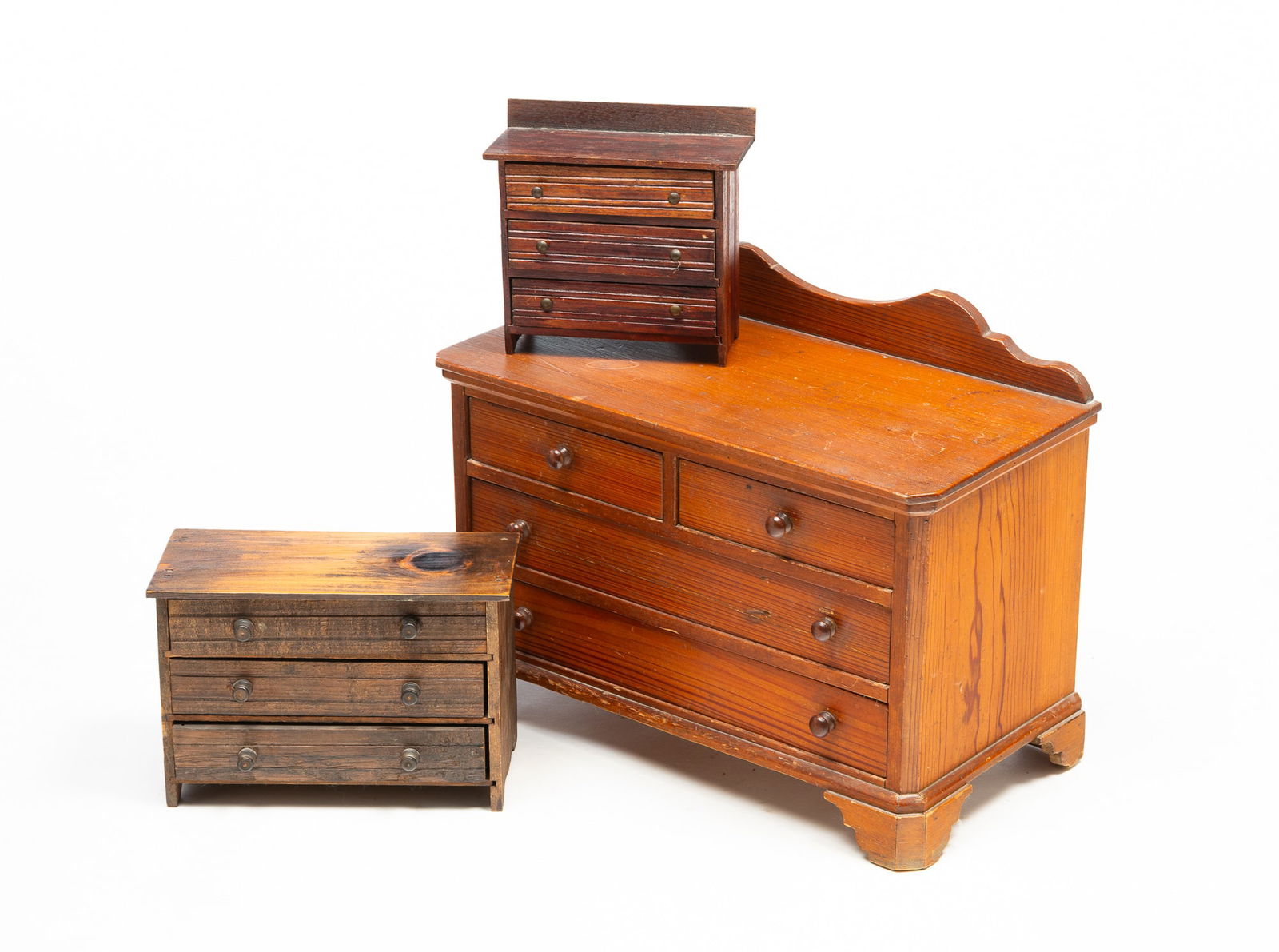THREE AMERICAN DIMINUTIVE CHESTS OF DRAWERS. Largest, 13.25"h. 17.5"w. (1 of 6)