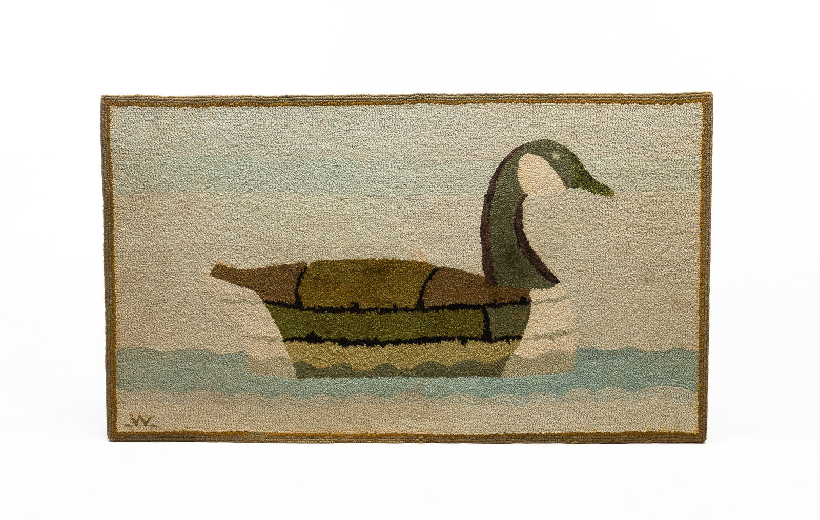 AMERICAN HOOKED RUG WITH CANADIAN GOOSE, SIGNED "W" AT LOWER LEFT.c: Mid-20th Century. Green and gray border with large central goose in green, brown, gray, and white floating on the water. 31"h. 54"w.