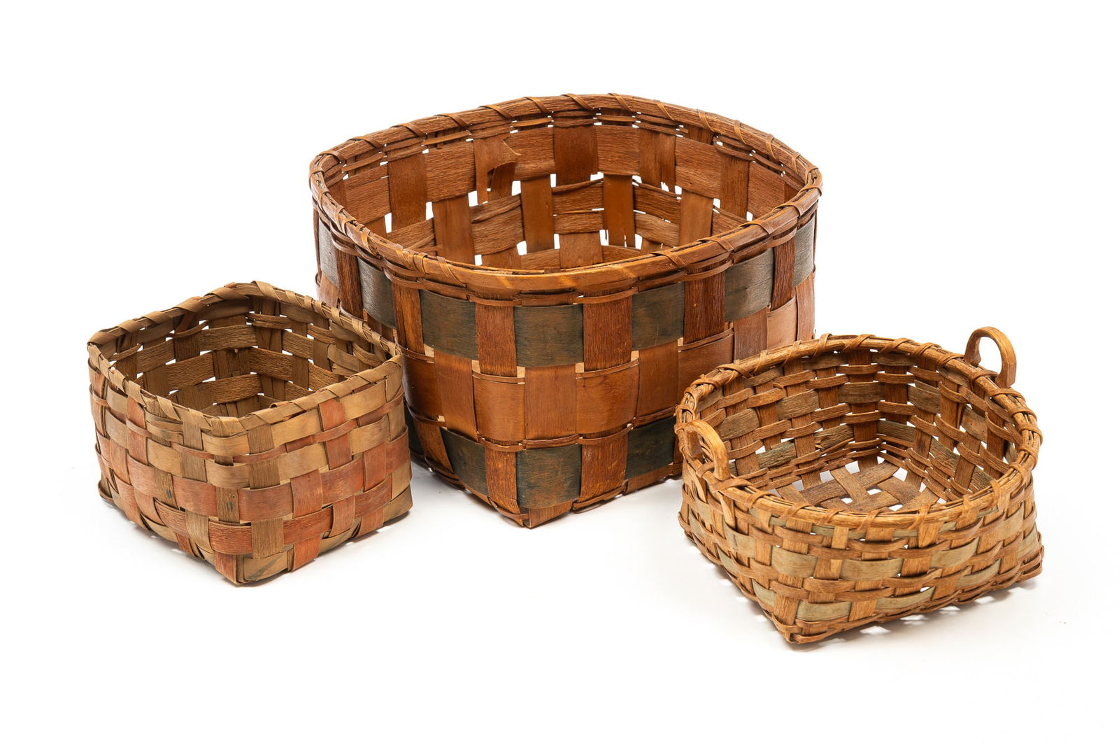THREE NORTHEAST NATIVE AMERICAN BASKETS. Largest, 7.5"h. 13"square.: Second half 19th Century. Two are square, the longer with blue bands and the second with red bands, together with a basket with light blue bands.SHIPPING: All purchases from Amelia Jeffers, Auctioneer