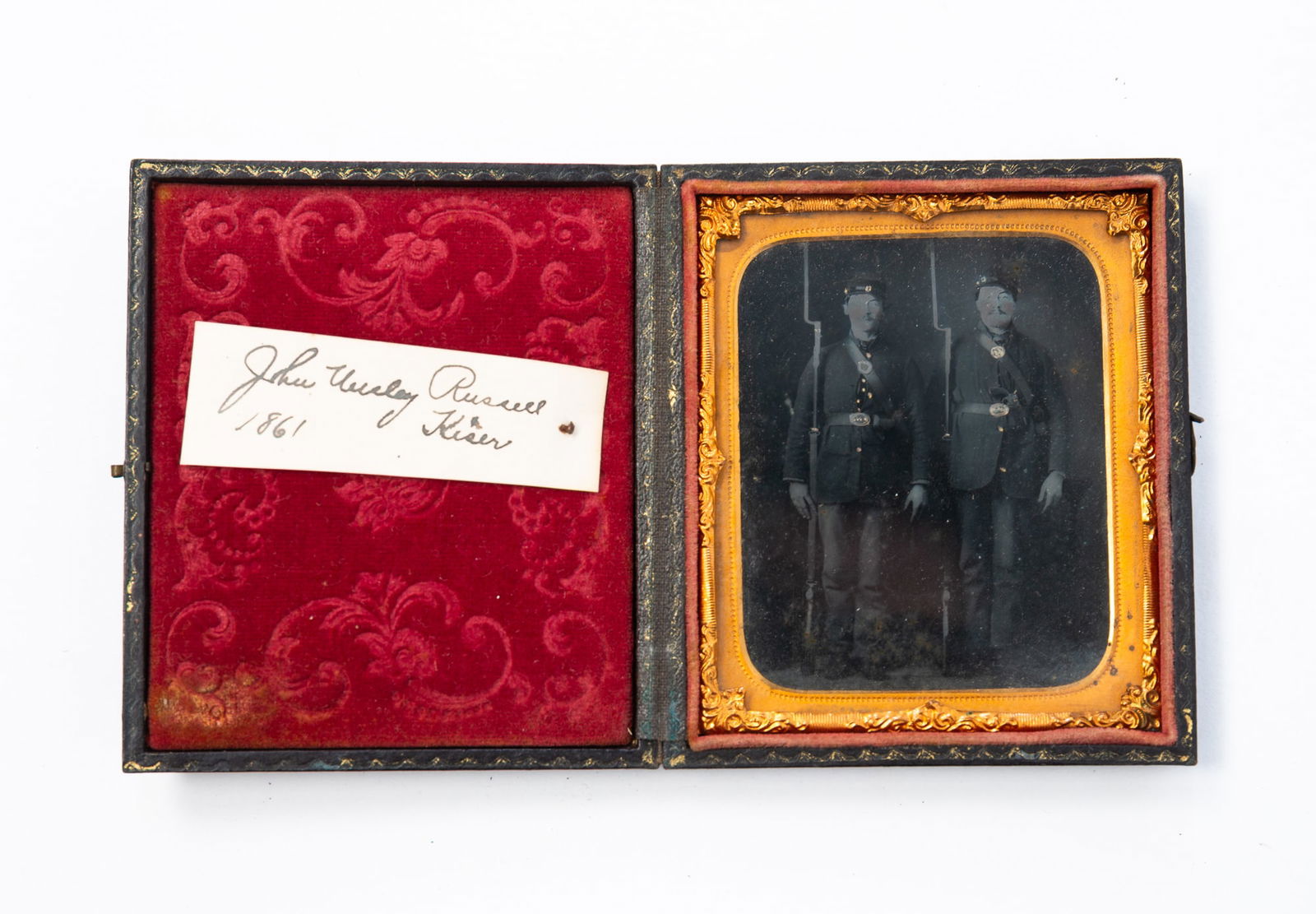 AMERICAN CASED CIVIL WAR TINTYPE. 3.5"h.: Third quarter 19th Century. Full-length view sixth plate of two uniformed Union soldiers with their rifles. Identified as John Wesley Russell and Kiser. Taken in 1861. In a case with gold-embossed eag