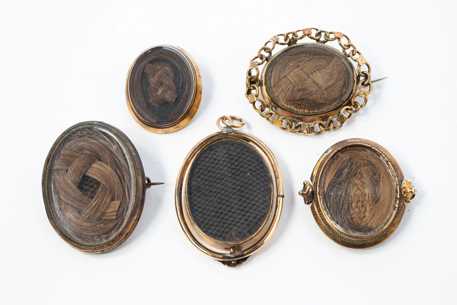FIVE VICTORIAN WOVEN HAIR-WORK MOURNING JEWELRY BROOCHES. (1 of 2)