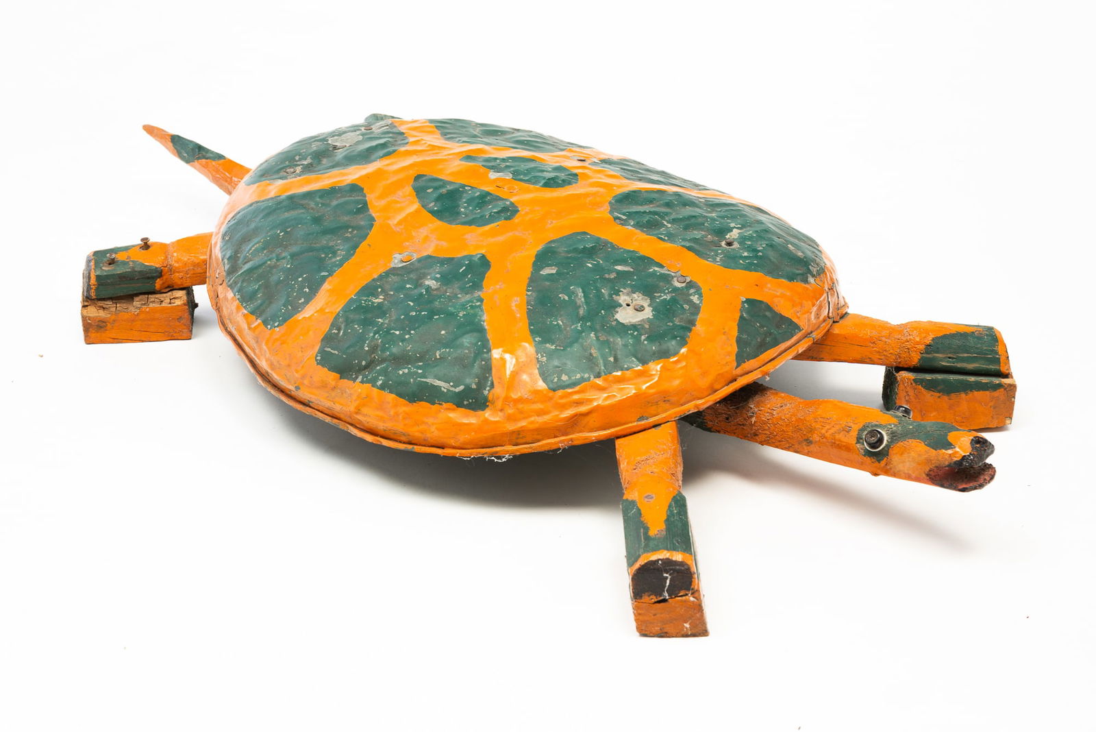AMERICAN OUTSIDER ART MIXED MEDIA TURTLE. 6"h. 14"w. 33"l.: Second half 20th Century. Galvanized trash can lid shell, carved bone head, tail and legs with block feet, rhinestone button eyes with orange and green paint.SHIPPING: All purchases from Amelia Jeffer