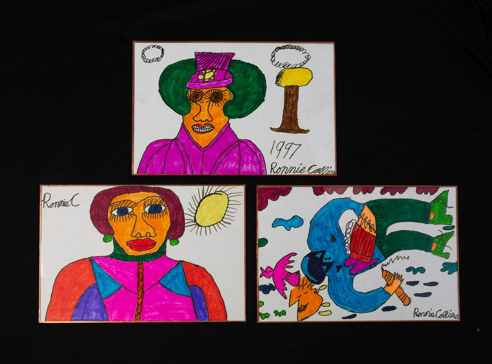 THREE RONNIE COLLINS (AMERICAN, 20TH/21ST CENTURY) OUTSIDER ART MARKER DRAWINGS, DATED 1997. 12.5"h.: On paper. Featuring two shoulder-length portraits as well as a full-body depiction with other figural motifs. Presented under plexiglass with gold-taped edges.Provenance: From the Lifetime Collection