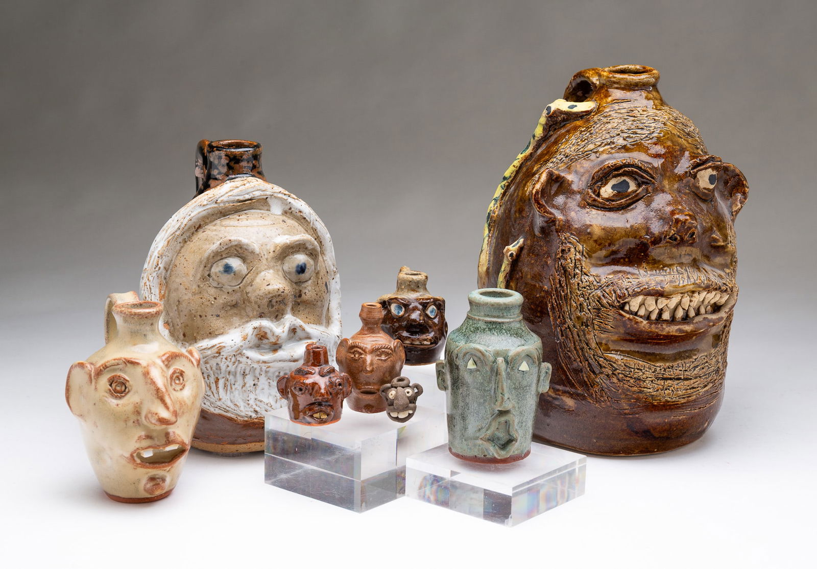 EIGHT SOUTHERN FOLK ART POTTERY FACE JUGS. Largest, 10"h. 6"d. (1 of 8)