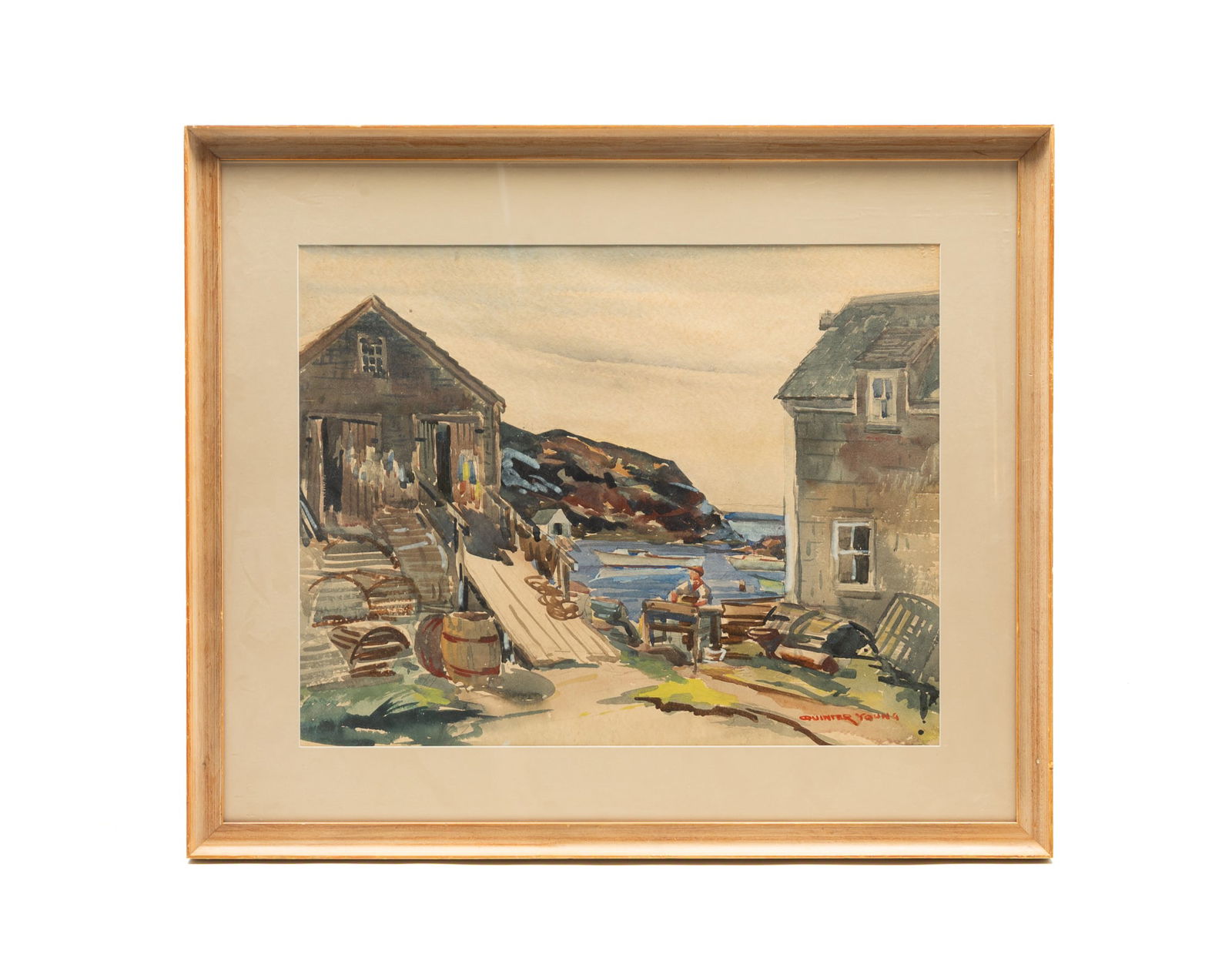 QUINTER YOUNG (AMERICAN, 1904-1975) "MOHEGAN ISLAND" WATERCOLOR. Frame, 26"h. 31"w.: 20th Century. On paper. Depiction of a man working outside of buildings and barrels along the water, with boats in the cove behind him, signed at lower right. In painted wood frame.Provenance: The Lif