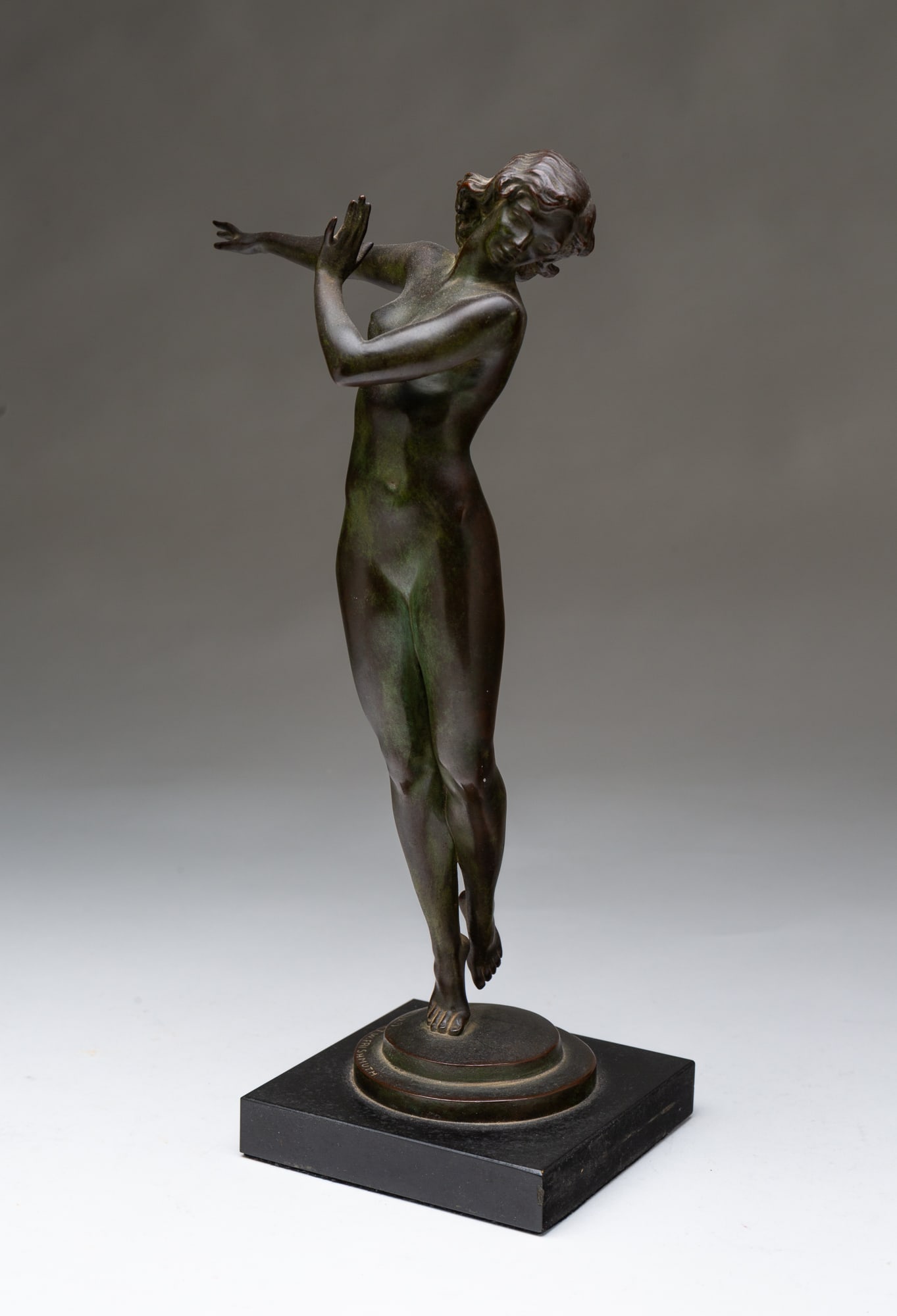 HARRIET WHITNEY FRISHMUTH (AMERICAN, 1880-1980) "ALLEGRA," 1929, BRONZE FIGURE.: Nude female figure with right arm outstretched and on tiptoes, with flowing hair, on a round pedestal and square black stone base, signed and dated on pedestal. 12.25"h. 6"w. 4.5"d. SHIPPING: All purc