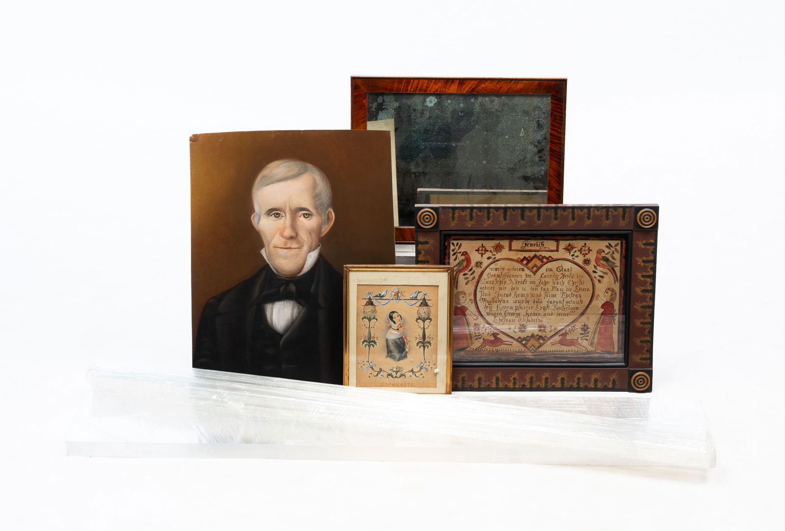 ECLECTIC GROUP OF FRAMED ITEMS AND A PASTEL PORTRAIT. Tallest (plexiglass panels), 45"h. 8"w.: American, 20th Century. Reproduction fraktur in a paint-decorated frame, a print of a young woman with birds, a tiger maple-framed shaving mirror (with standard), a six-sided plexiglass frame, and a p