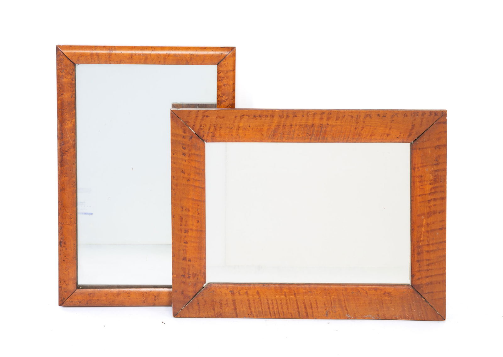 TWO FIGURED MAPLE MIRRORS. The larger, 14.25"h. 18.25"w. (1 of 3)