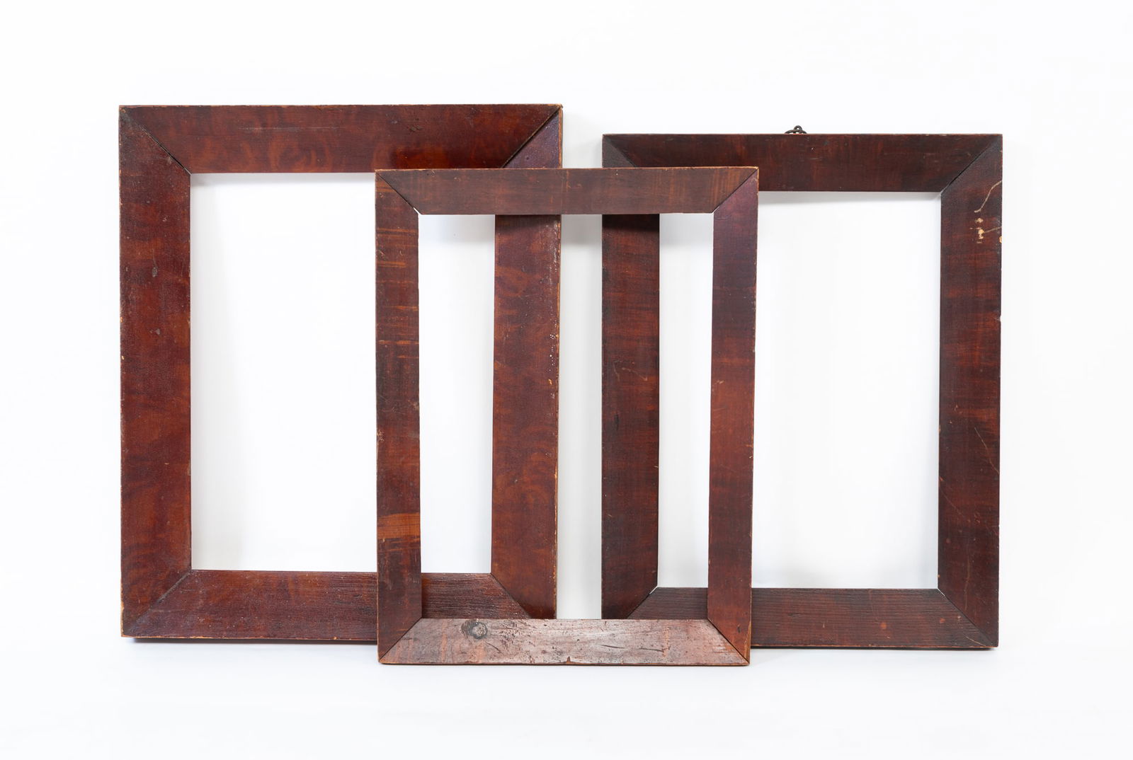 THREE GRAIN-PAINTED WOOD PICTURE FRAMES. The largest, overall, 18.5"h. 15"w. (1 of 4)