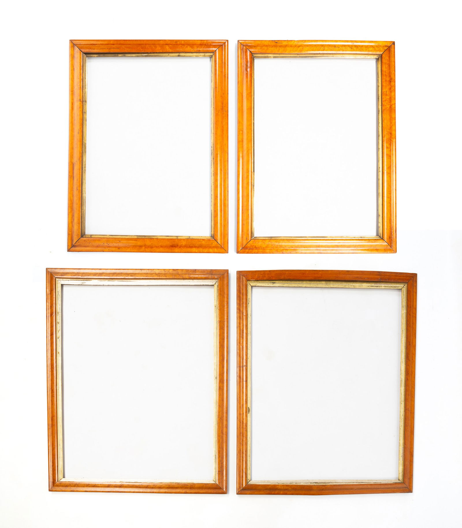 TWO PAIRS OF BIRD'S-EYE MAPLE PICTURE FRAMES. Largest, overall, 29.75"h. 24.25"w.: American or English, 19th Century. Veneered. All having an ogee profile and gilt liner. First pair, each, rabbet, approx. 27.5"h. 22"w. Overall, 29.75"h. 24.25"w. Second pair, each rabbet, approx. 25"