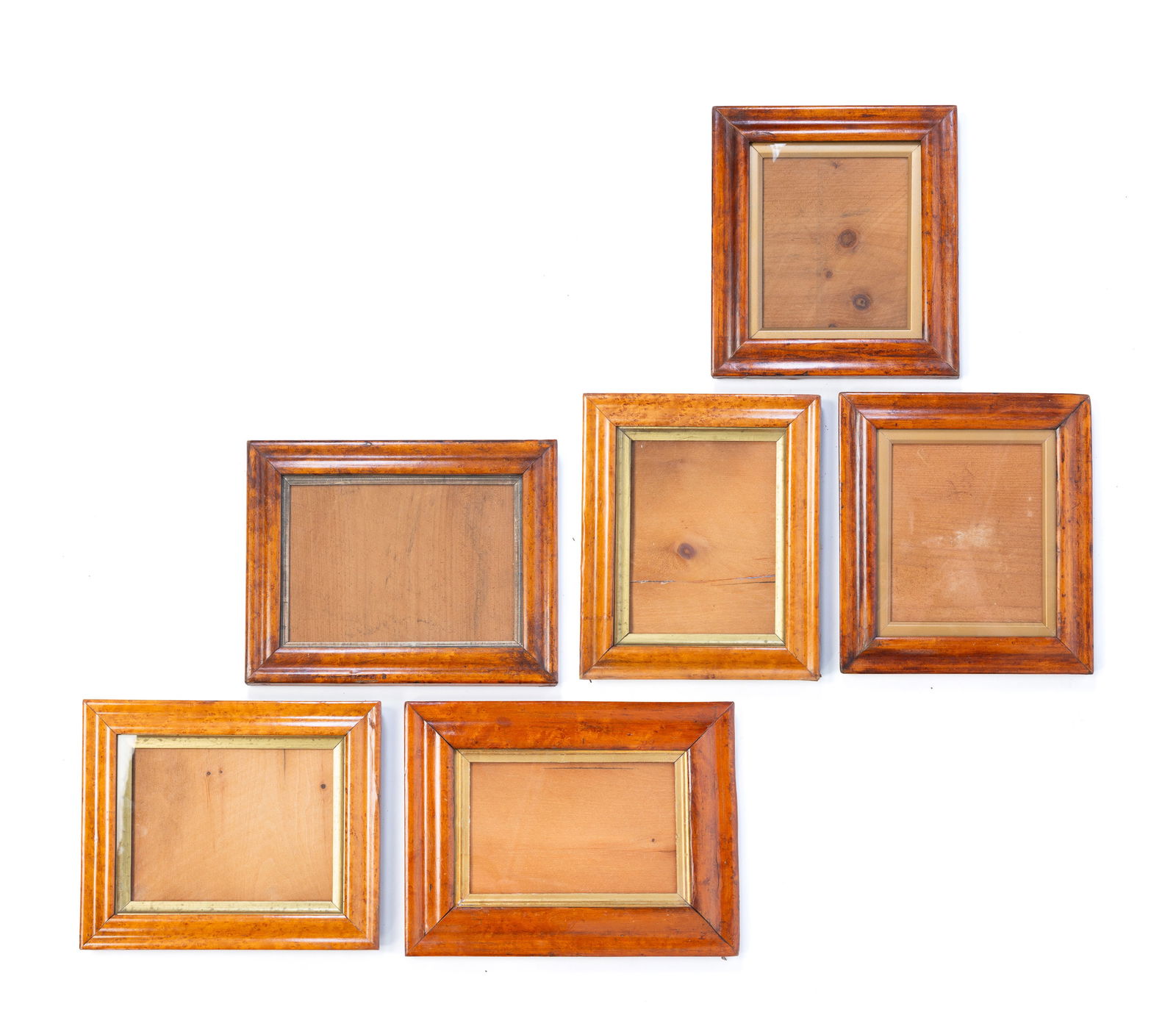 SIX BIRD'S-EYE MAPLE PICTURE FRAMES. Largest, overall, 10.25"h. 11.25"w. Smallest, overall, 9.5"h.: American and/or English, 19th Century. Veneered. Ogee profiles, gilt liners, glass, and pine backing boards.Provenance: From the Collection of Peggy McClard & Randy Segotta (Weare, New Hampshire).SHIP
