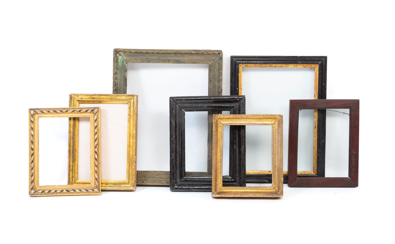 SEVEN DIMINUTIVE WOOD PICTURE FRAMES. Largest, overall, 11.75"h. 9.5"w.: American, Late 19th-Early 20th Century. Of various finishes, profiles, and sizes, some having glass. Largest, overall, 11.75"h. 9.5"w. Smallest, 7"h. 5.75"w.Provenance: From the Collection of Peggy Mc