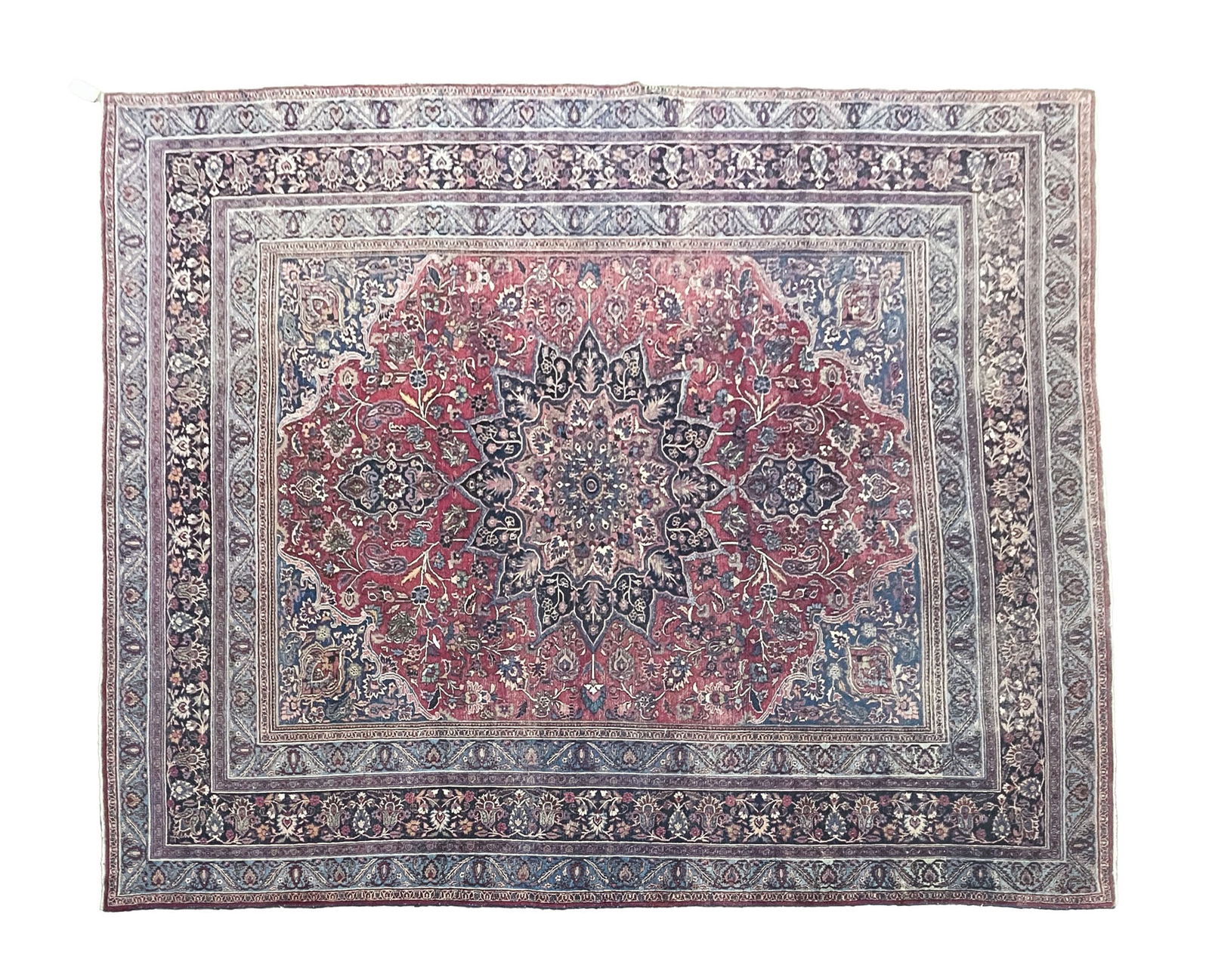 PERSIAN HERIZ WOOL ROOM-SIZE RUG. 125.25"w. 161.5"l.: Iran, Early 20th Century. Central blue medallion on red field filled with vining floral and foliate motifs, with stylized floral and foliate borders of blue, red, green, and cream.SHIPPING: All purcha