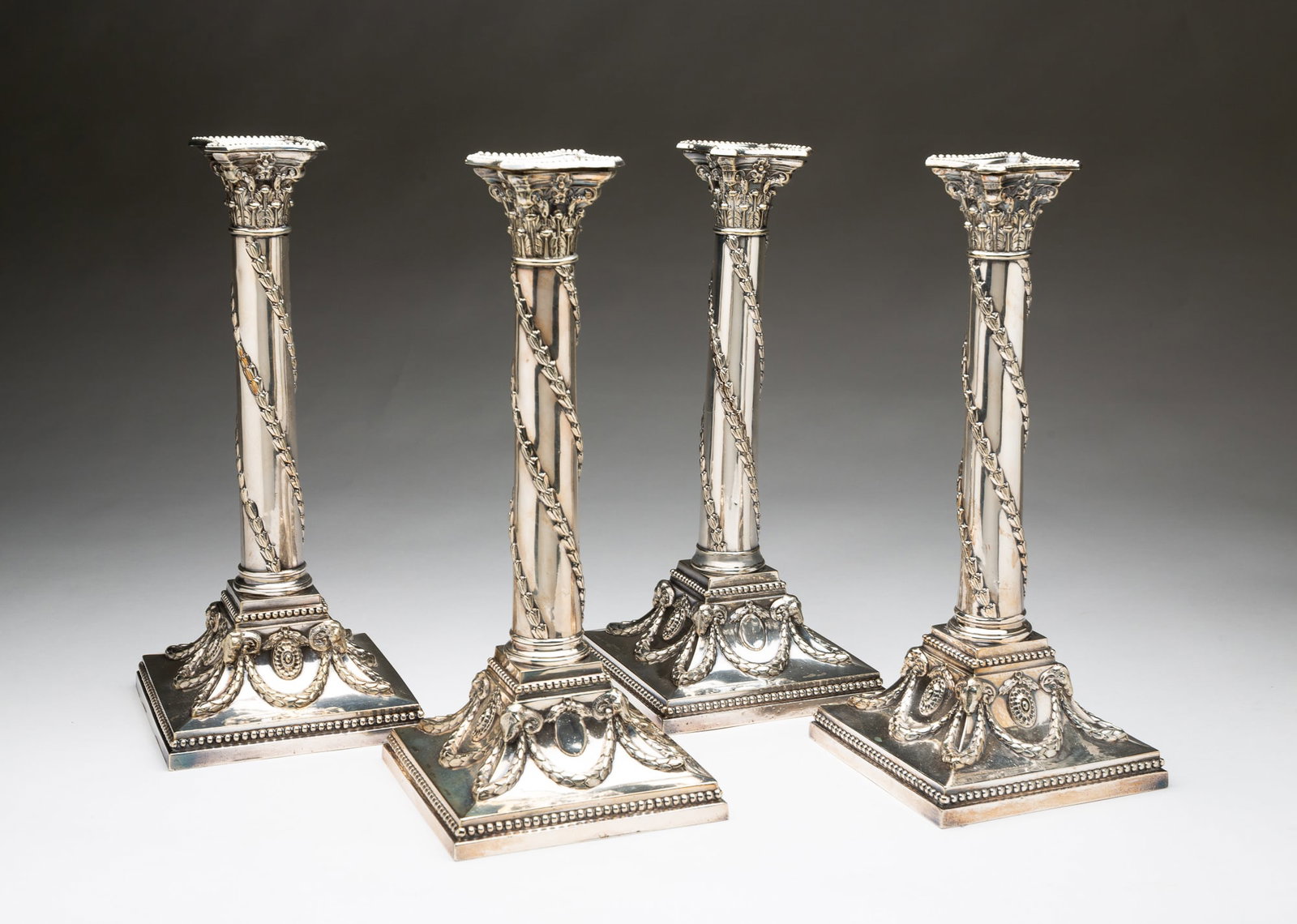 FOUR SHEFFIELD PLATE CANDLESTICKS. (1 of 6)