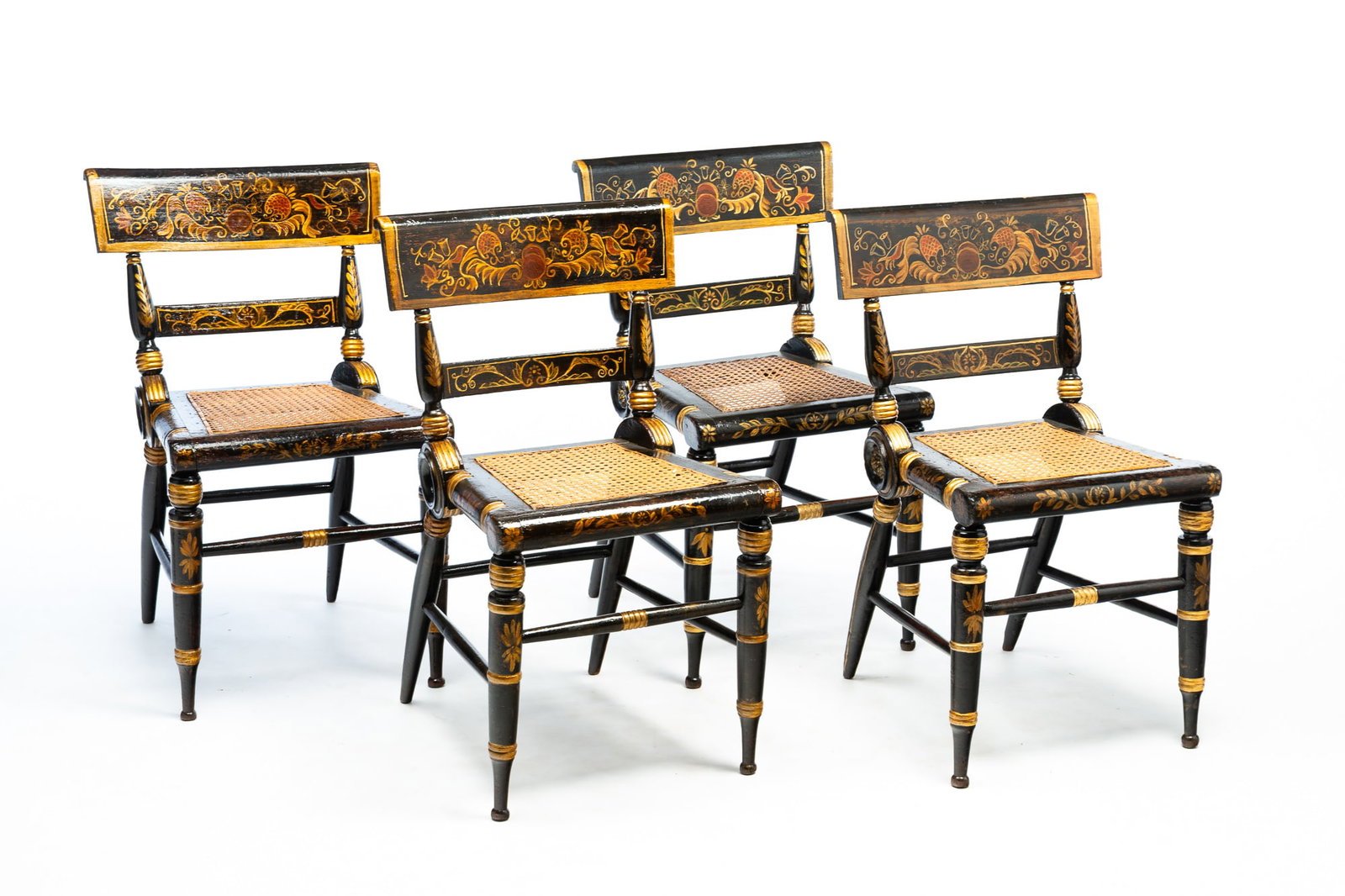 FOUR BALTIMORE EBONIZED AND GILT-DECORATED "FANCY" SIDE CHAIRS.: American, Second quarter 19th Century. Mixed woods. Bold turnings, black paint, floral decoration, gold trim, flourishes, and cane seats. 18" seat ht. 31.5"h.