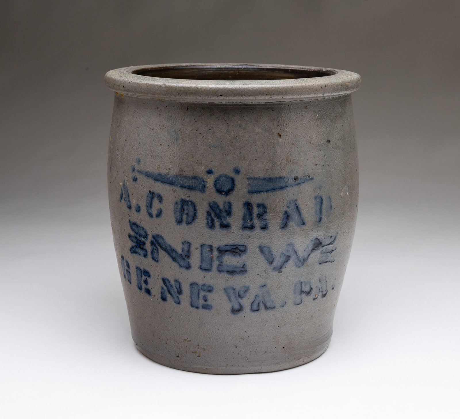 A. CONRAD (NEW GENEVA, PENNSYLVANIA) COBALT-DECORATED STONEWARE JAR.: American, Second half 19th Century. Slightly ovoid shape and cobalt stenciled "A. CONRAD, NEW GENEVA, PA." 8.25"h. 7.5"d.