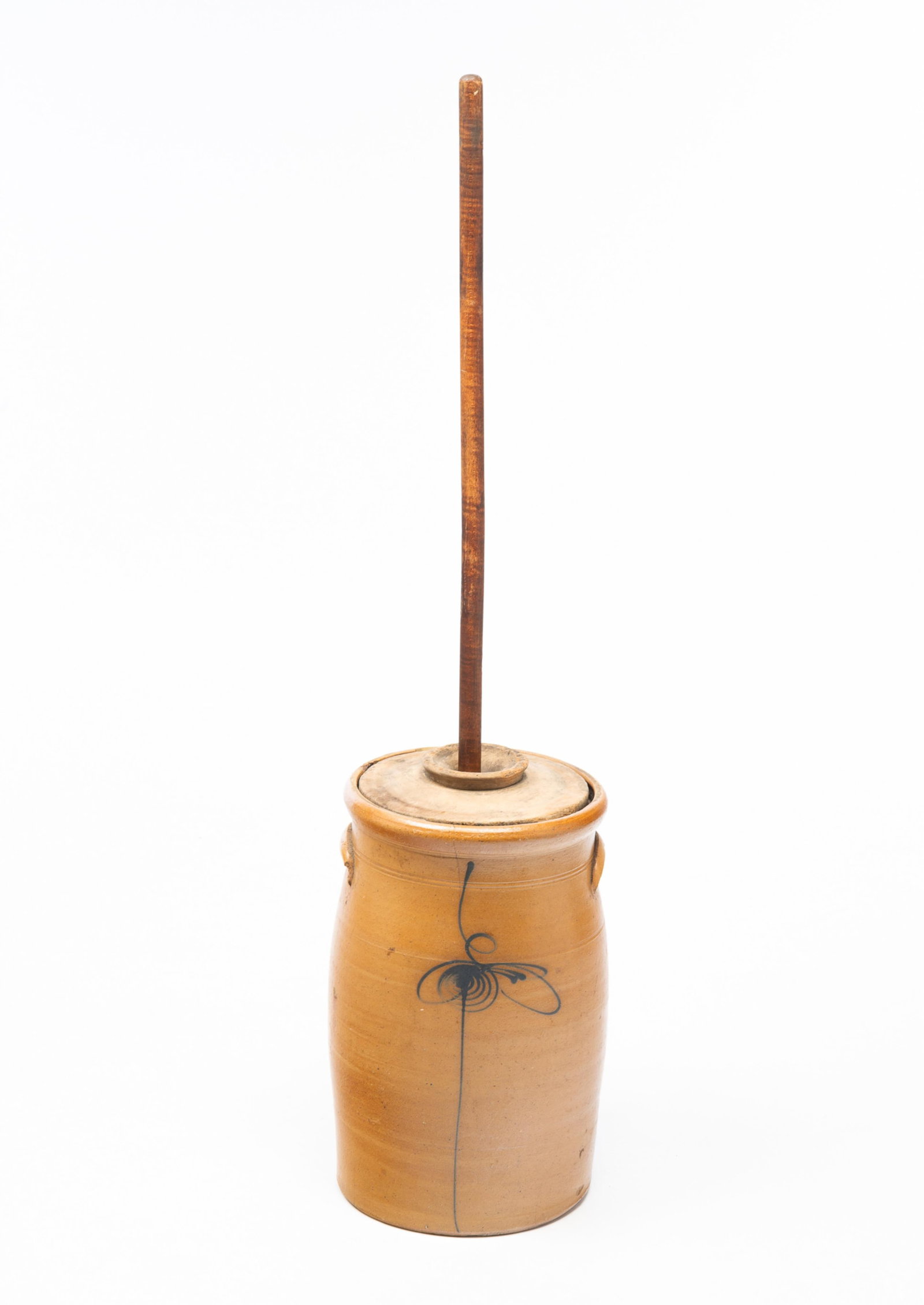 AMERICAN COBALT-DECORATED STONEWARE SIX-GALLON CHURN.: Mid-19th Century. Cylindrical form, pronounced lip, two incised lines, applied lug handles, and freehand cobalt "6" and bee stinger. With wood lid and dasher. Jar, 16.5"h. Overall, 43.5"h.Provenance: