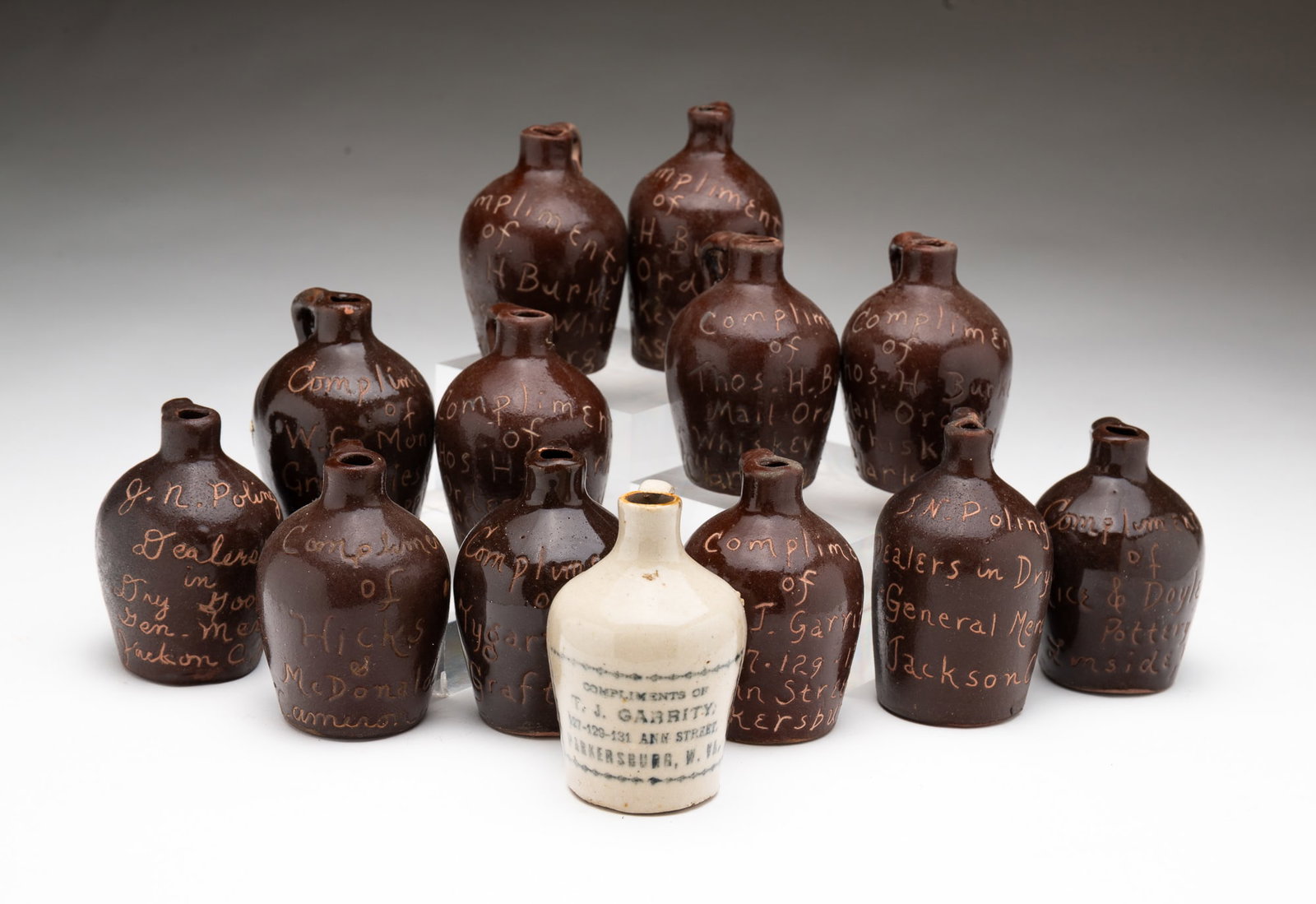 GROUP OF THIRTEEN MINIATURE STONEWARE WEST VIRGINIA ADVERTISING JUGS. (1 of 7)