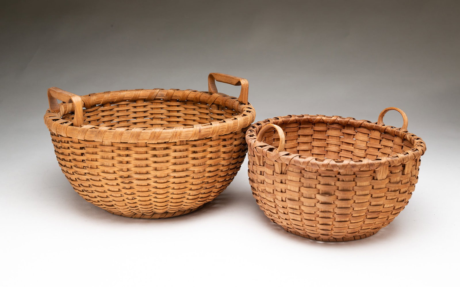 TWO AMERICAN SPLINT-WOVEN DOUBLE-HANDLED BASKETS. (1 of 4)