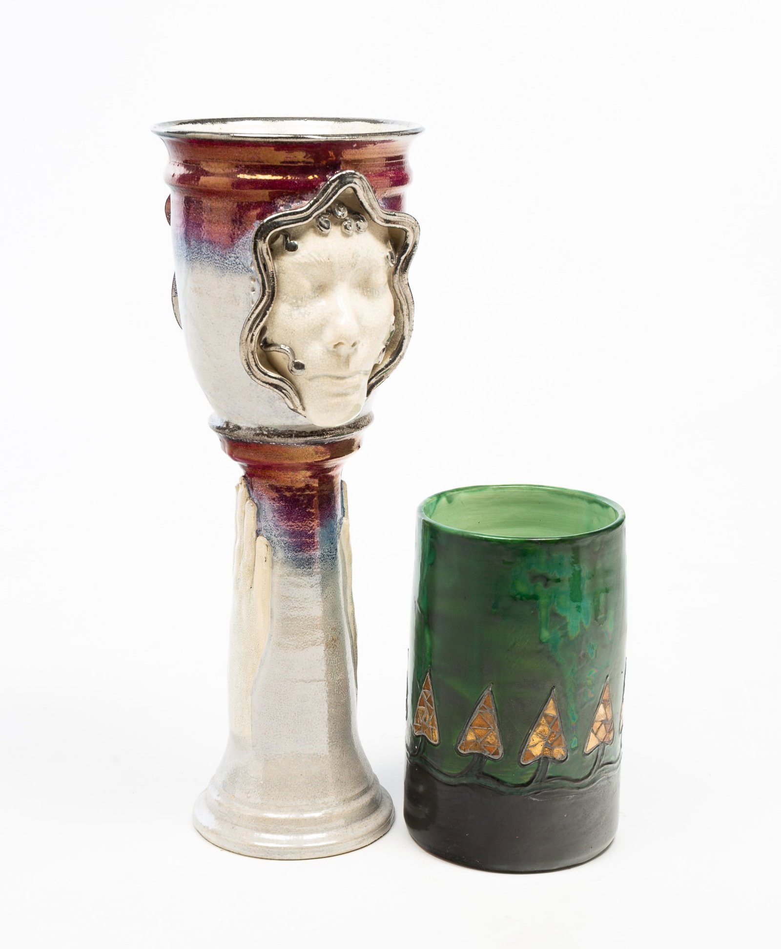 TWO PIECES OF EUROPEAN ART POTTERY.: 20th Century. A German cylinder vase with impressed mark Muster Gesetzl Geschtzt. Mottled green and black high glaze with stylized gold glass trees, 10"h. 6.25"d., and an Art Deco-style pedestal plant