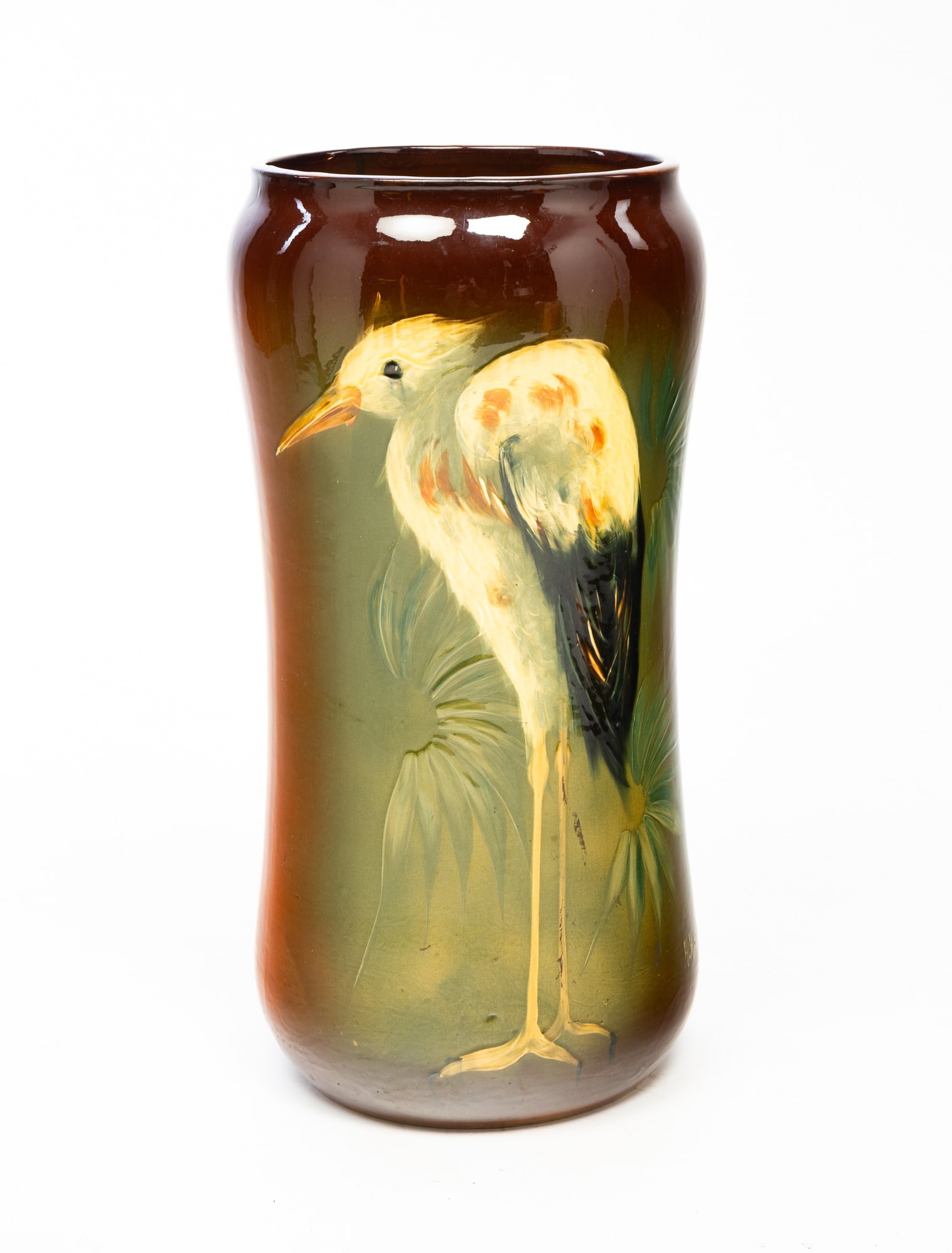 ALBERT HAUBRICH (GERMAN, ACTIVE 1897-1903) FOR J.B. OWENS POTTERY CO. (ZANESVILLE, OHIO) UMBRELLA: American, ca. 1896. Having a pronounced top rim and cinched waist, with underglaze slip painting of a crane, signed "A. Haubrich" at bottom edge. 22.25"h. 11"w.Cataloger's Note: An example of this wor
