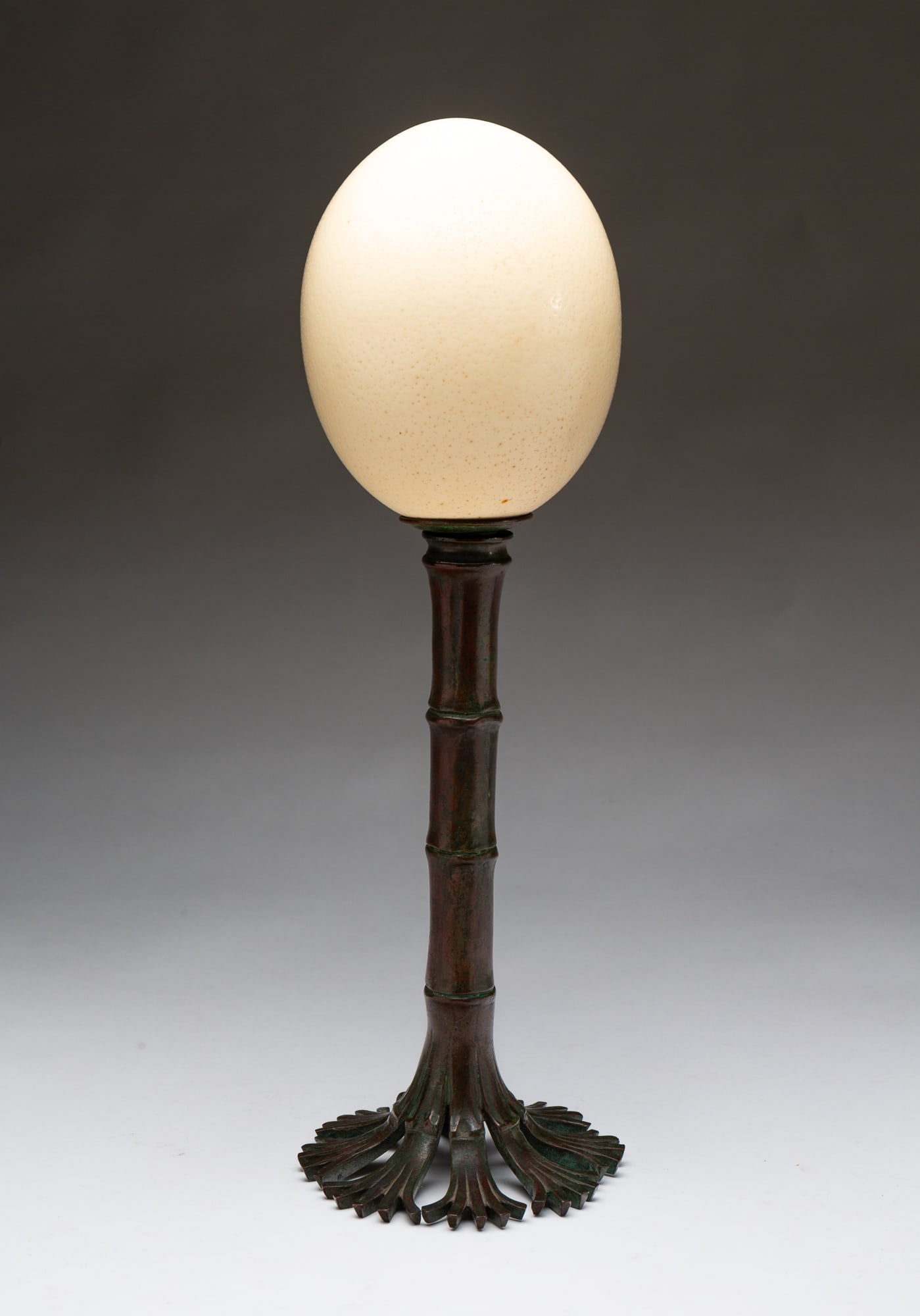 OSTRICH EGG ON MARKED TIFFANY BAMBOO BRONZE BASE.: American, 20th Century. Mounted ostrich egg on base with questionable Tiffany Studios mark on bottom. 16"h.