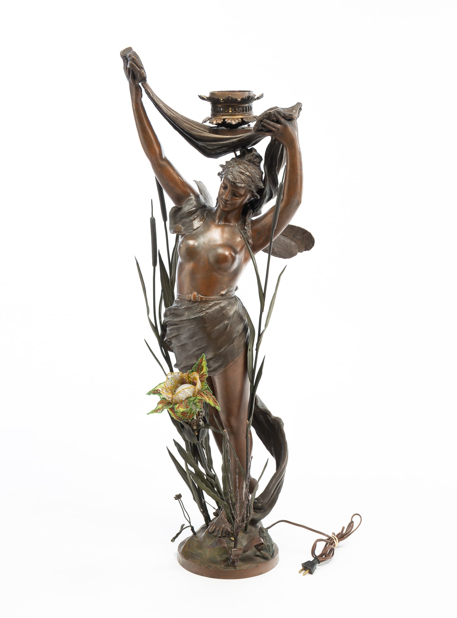 LARGE AMERICAN ART NOUVEAU WINGED NYMPH NEWEL POST LAMP.: LARGE AMERICAN ART NOUVEAU WINGED NYMPH NEWEL POST LAMP. Ca. 1900. Spelter. Scantily clad female figure with arms raised holding a draping cloth. She is posed surrounded by cattails. A beaded floral l