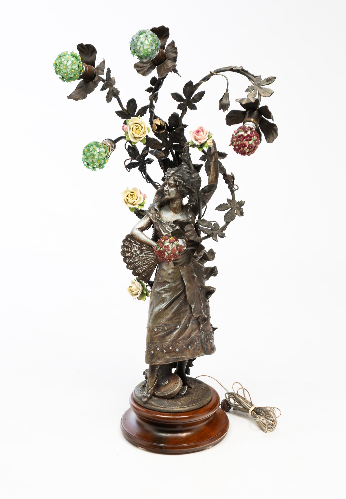 AMERICAN ART NOUVEAU NEWEL POST LAMP.: AMERICAN ART NOUVEAU NEWEL POST LAMP. Ca. 1900. White metal. Lady in a flowing gown holding a fan at her hip, surrounded by foliage, holding five light bulbs having beaded covers interspersed with cer