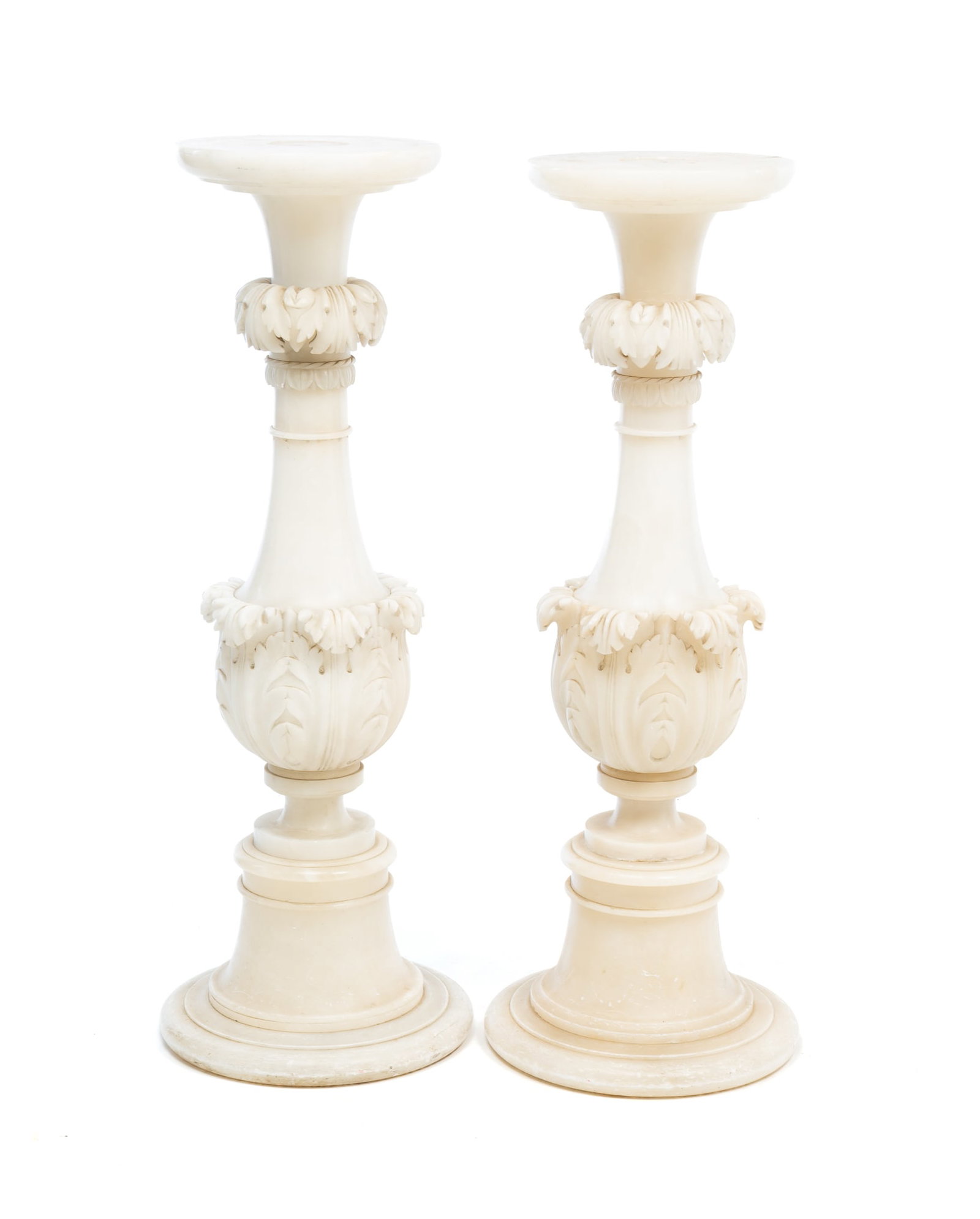 PAIR OF EUROPEAN MARBLE PEDESTALS.: Ca. 1900. Round tops tapering down to a baluster column with two bands of foliate carving on round plinths with concave sides. 39.75"h. 11"d.