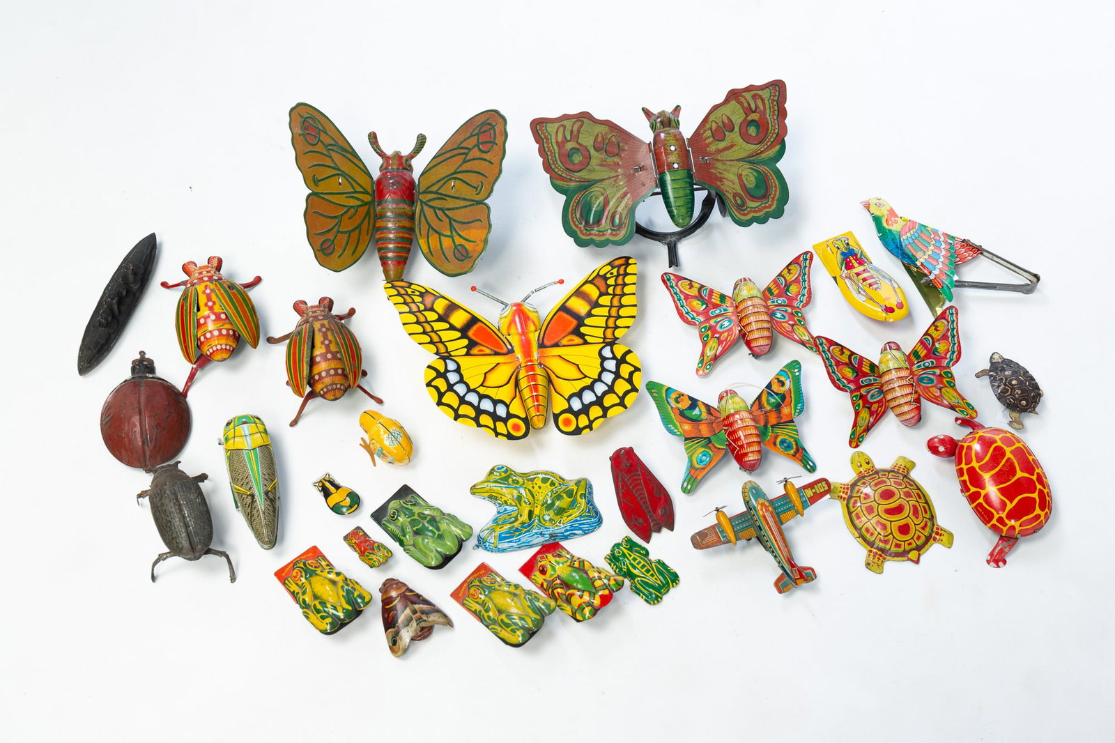 LARGE GROUP OF LITHOGRAPHED TIN ANIMAL TOYS.: American and Japanese, 20th Century. Includes clickers, wind-up toys, and others. Also includes a plastic boat and a tin plane. Largest, 8"w.