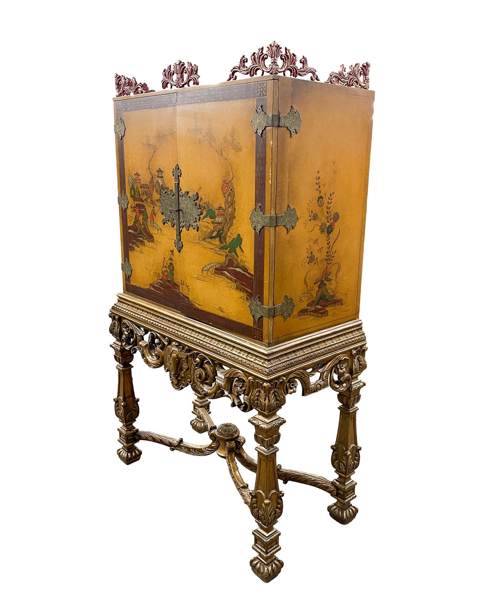 AMERICAN CHINOISERIE CABINET-ON-STAND.: First half 20th Century. In two pieces. Top with foliate-carved red and gold corner brackets, ocher lacquered case with Chinese outdoor scenes, and ornate brass hardware. Base with ornate carved