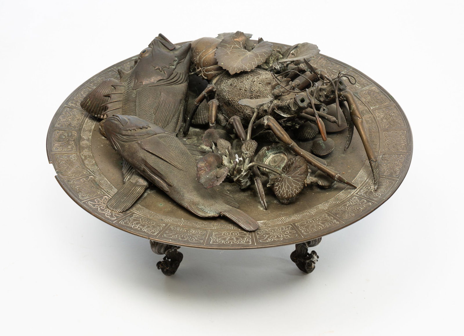 ASIAN BRONZE SCULPTED SEALIFE ARRANGEMENT.: 20th Century. A round bronze bowl filled with sculpted fish, lobster, clams, and mollusks sitting atop a decorative pedestal. 10"h. 16"d.Provenance: From the late George Shahady (Bridgeport, West