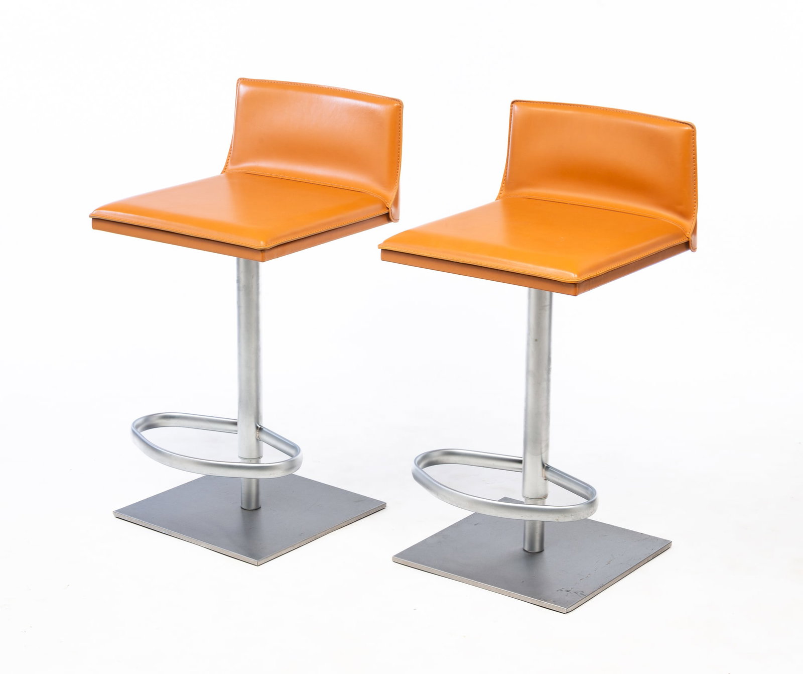 PAIR OF FRAG SRL (MILAN, ITALY) MODERNIST BRUSHED STEEL AND LEATHER BAR STOOLS.: Late 20th Century. Brushed steel bases and footrest with leather seats and backs. 32"h. 25" seat h.