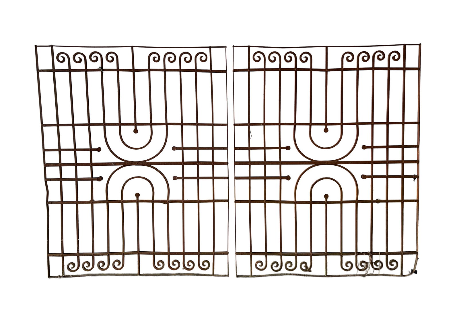 PAIR OF AMERICAN WROUGHT IRON GATES.: PAIR OF AMERICAN WROUGHT IRON GATES. 20th Century. Centers with arches and inverted arches, flanked by grids and top and lower borders having scrolled ends. 73.75"h. 58.75"w. each leaf. Provenance: Fr